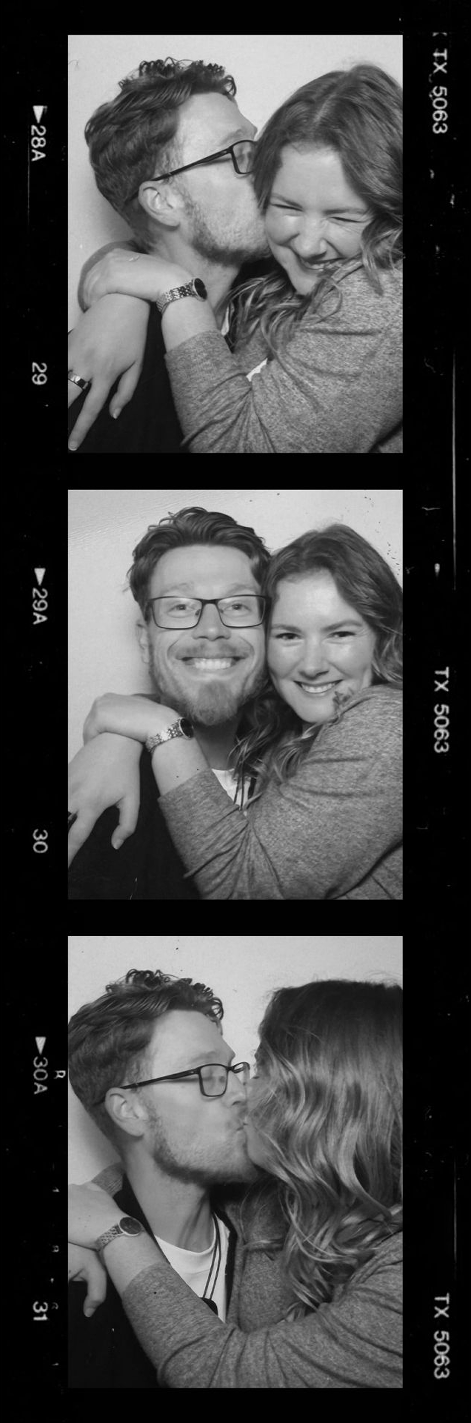Black and white photo booth strip of a playful couple kissing and embracing.
