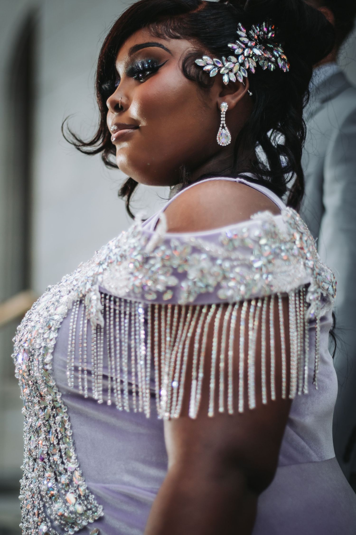 Close-up details of lavender dress with crystal beading and fringe embellishments.