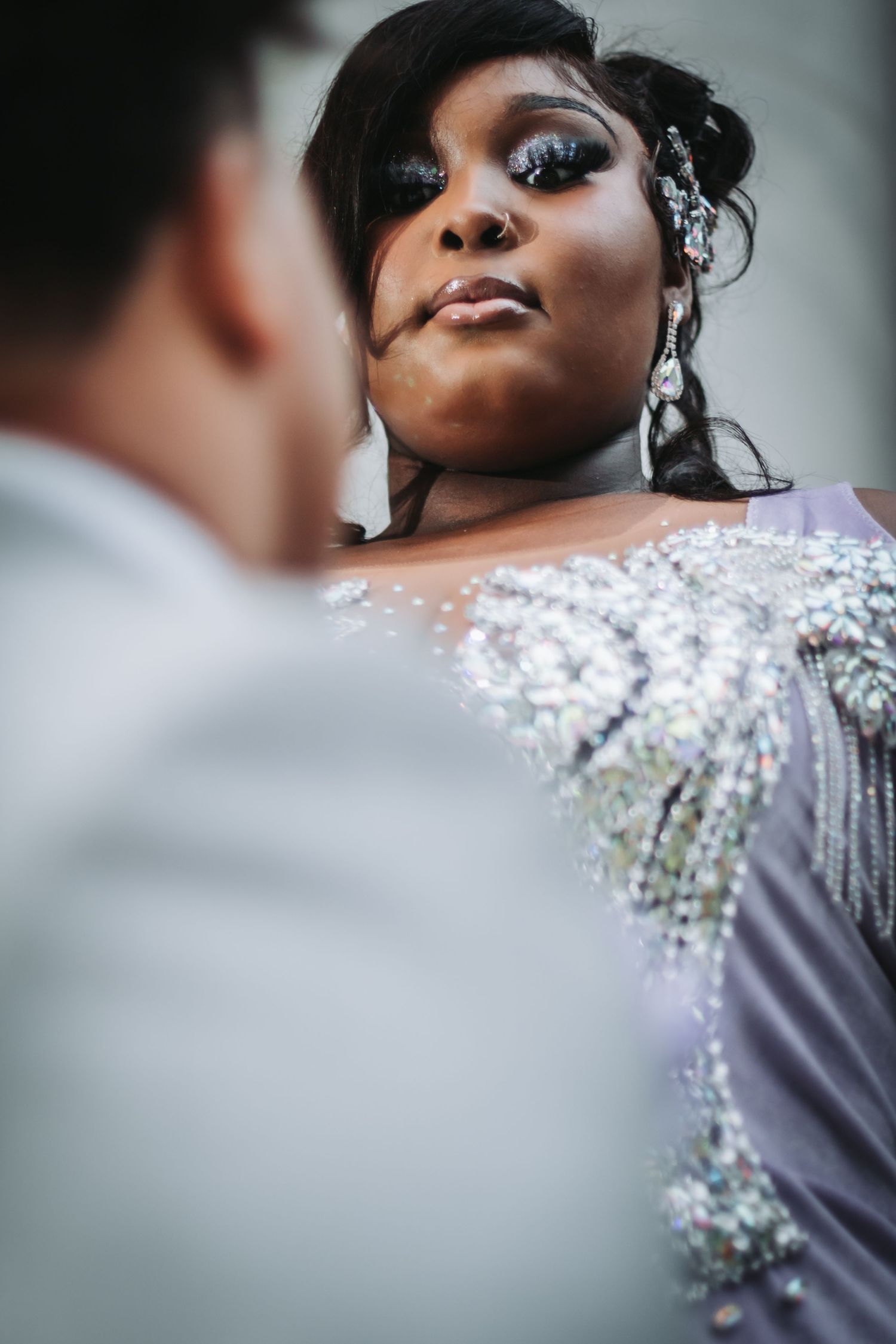 Close-up of sparkling sequined dress detail in elegant wedding photography.