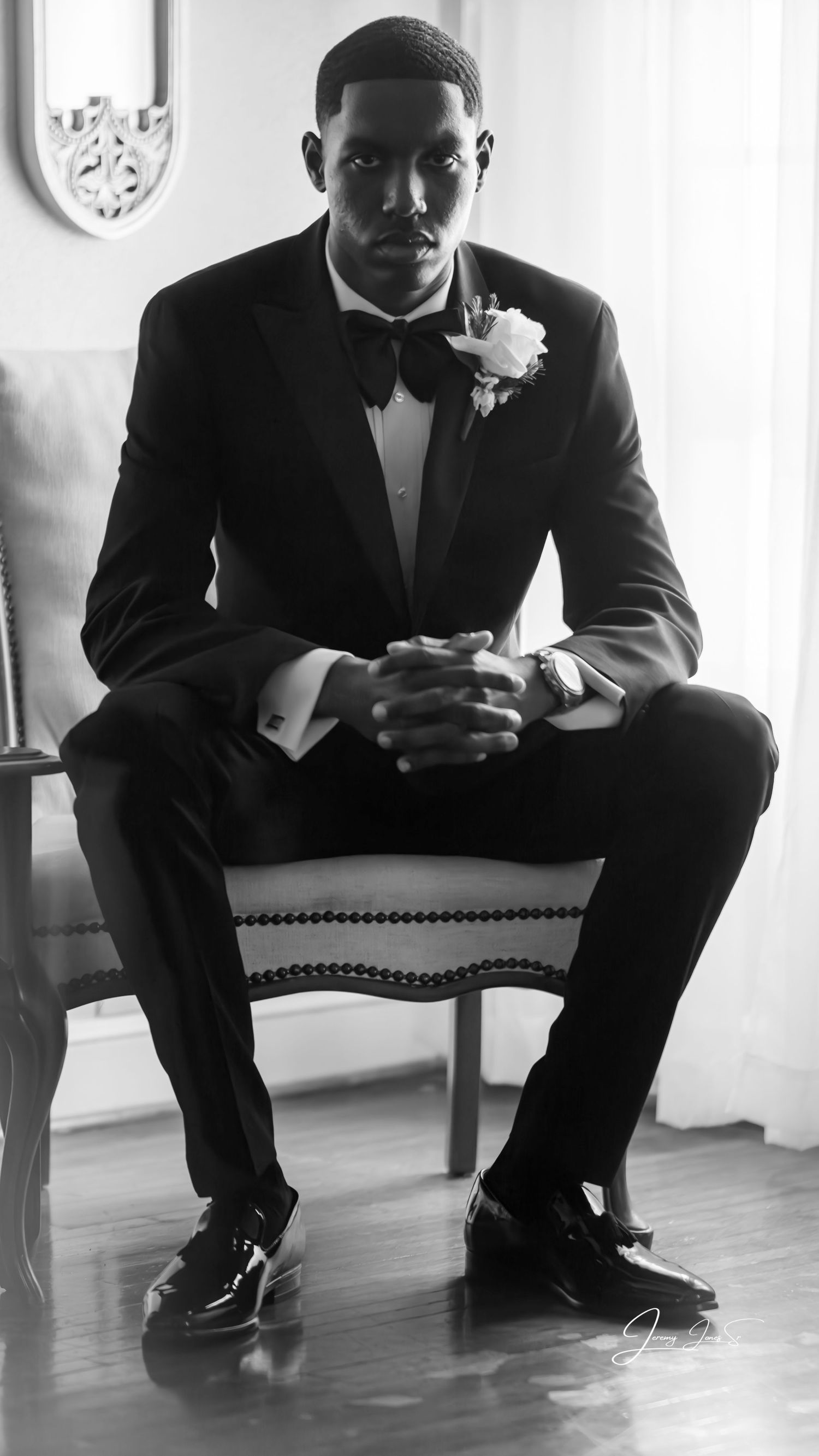 Black and white portrait showing formal attire and classic pose.