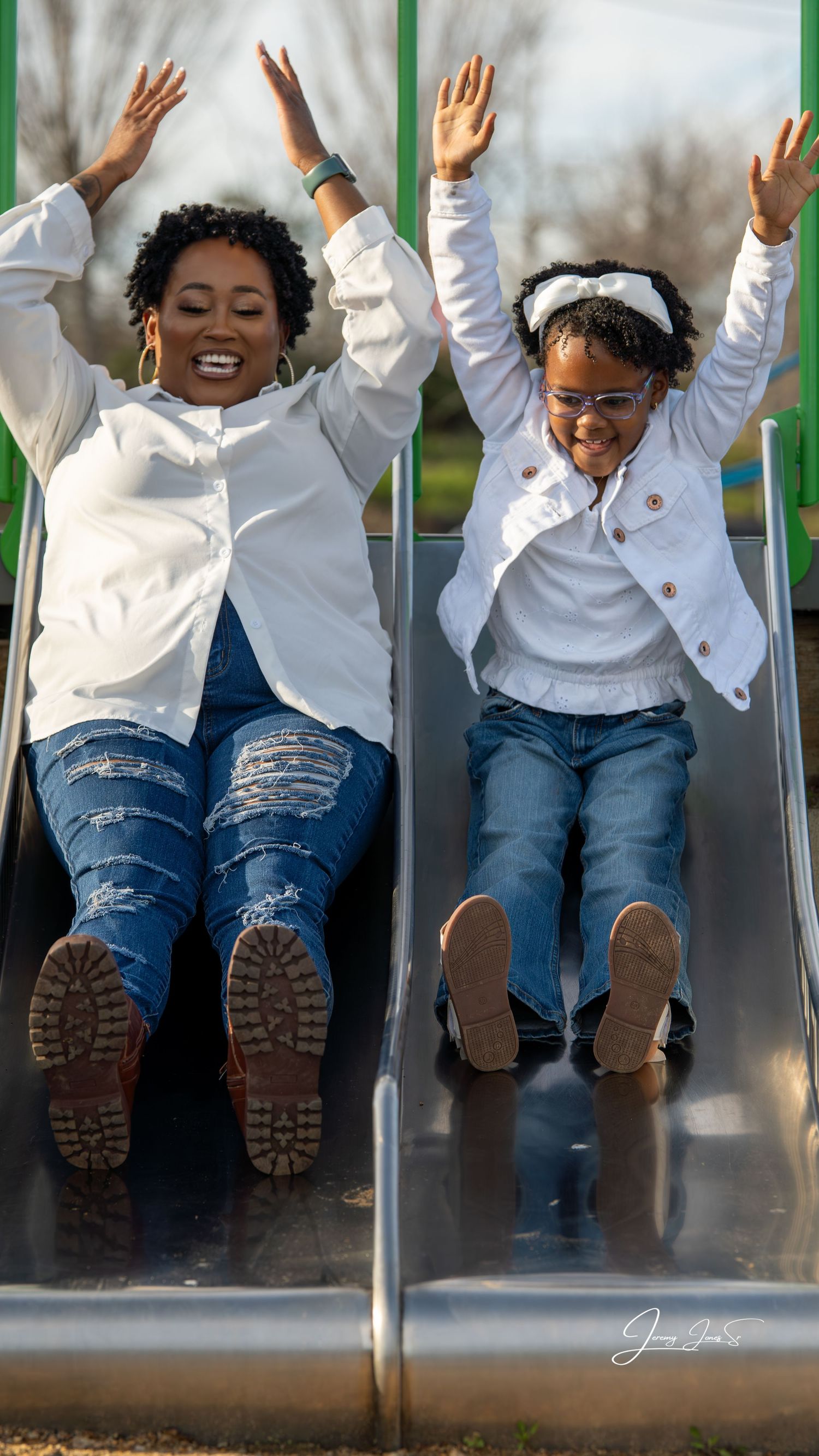 Playful sequence of someone sliding down wearing white jacket and jeans.