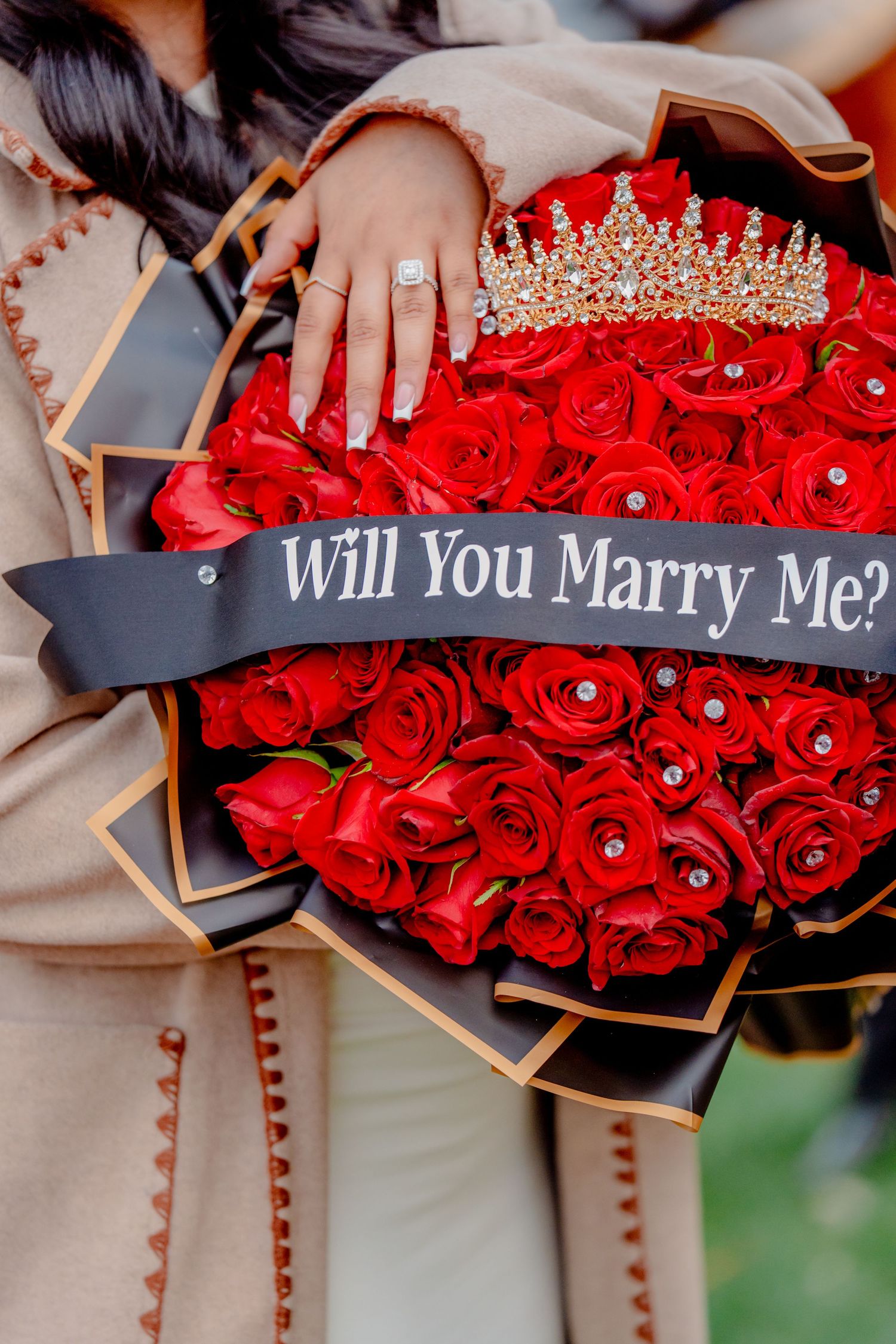 Romantic proposal moment with red roses and engagement ring during a surprise proposal captured by a couples photographer.