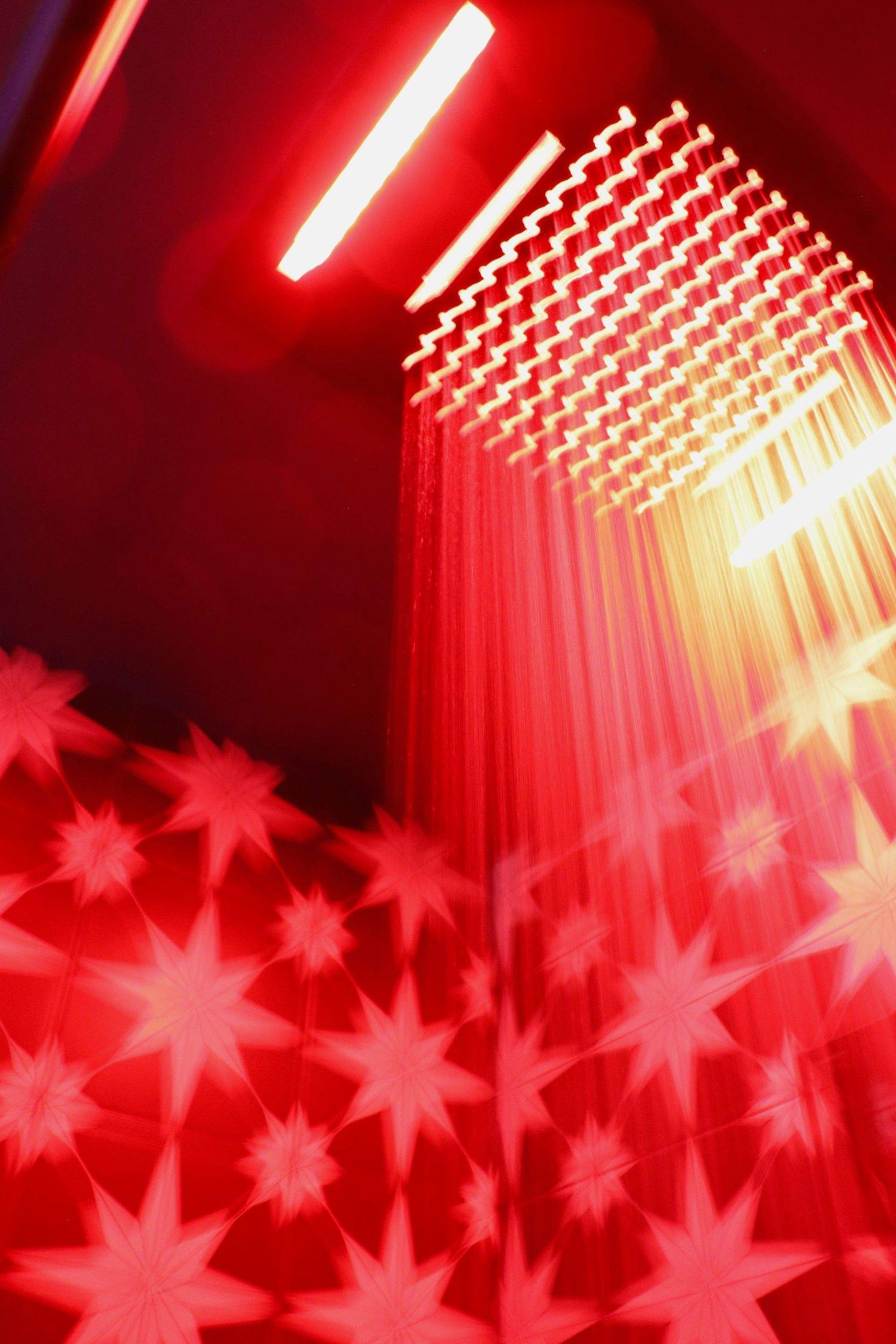 Denver, Colorado creative red lighting installation with geometric light patterns captured in artistic interior and event space photography.