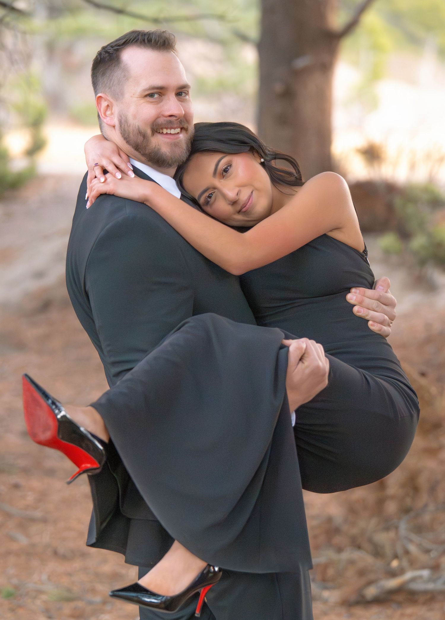 Romantic couple portrait with mountain forest backdrop during a outdoor engagement photography session captured by a Colorado photographer.