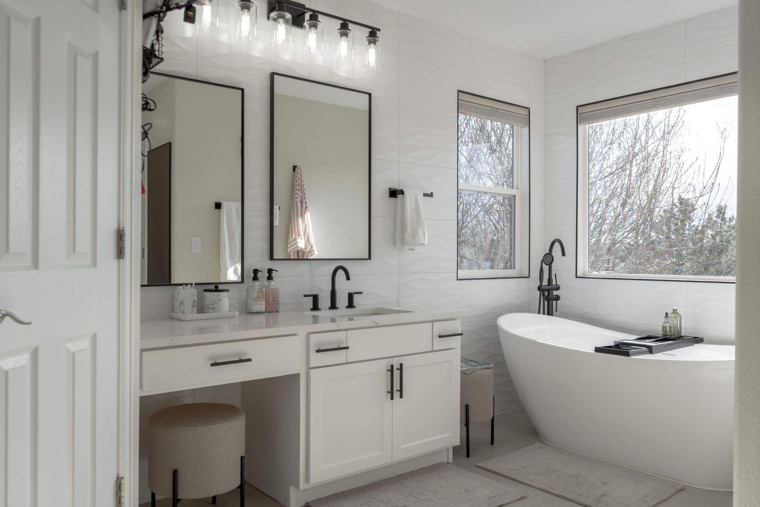 Spacious Colorado bathroom with freestanding tub and double vanity photographed for interior design and real estate marketing photography.