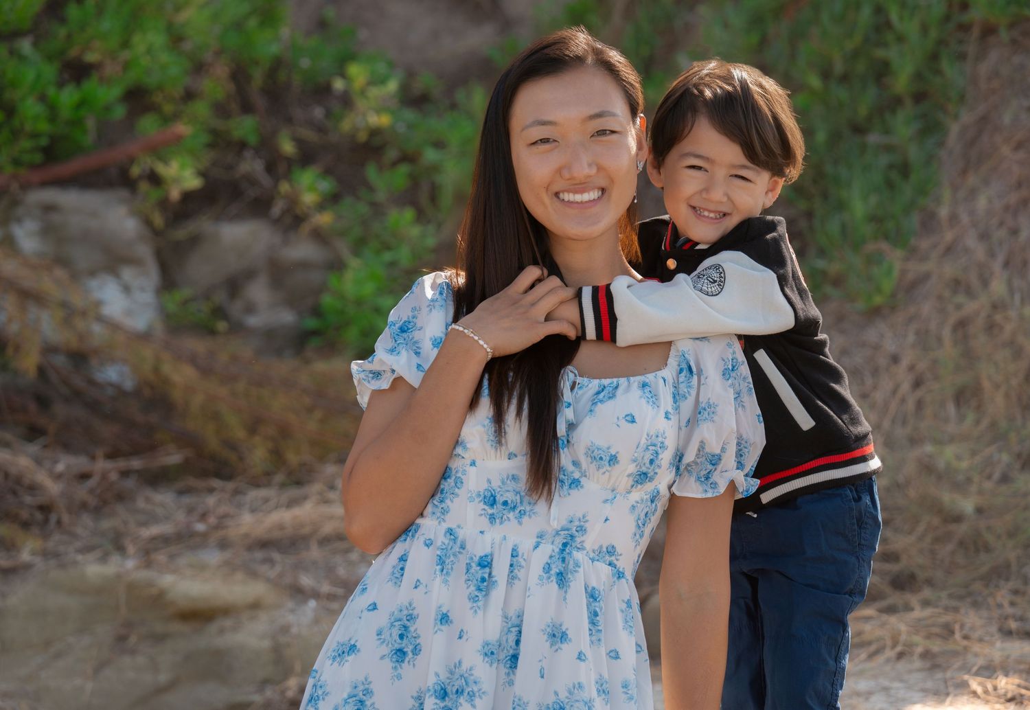 Smiling mother and child embracing during a natural family portrait session photographed by a Denver family photographer.