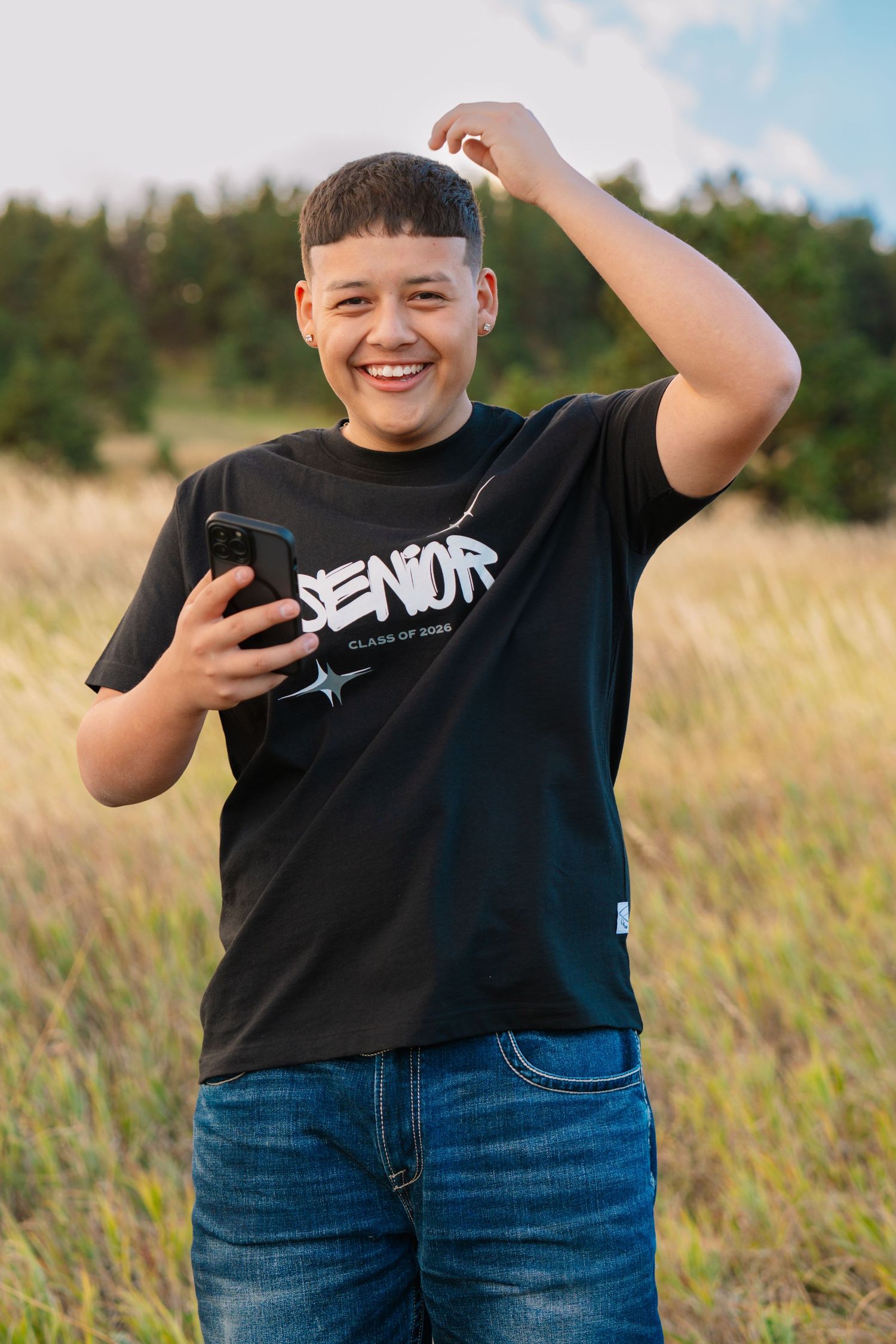 High school senior portrait in open field at Chautauqua Park with Boulder Flatirons during a Colorado senior photography session.