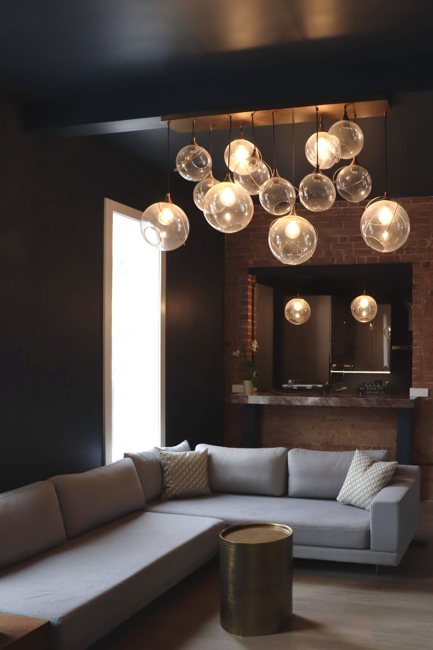Elegant lounge area with statement glass chandelier lighting and modern seating captured for architectural and interior design photography.