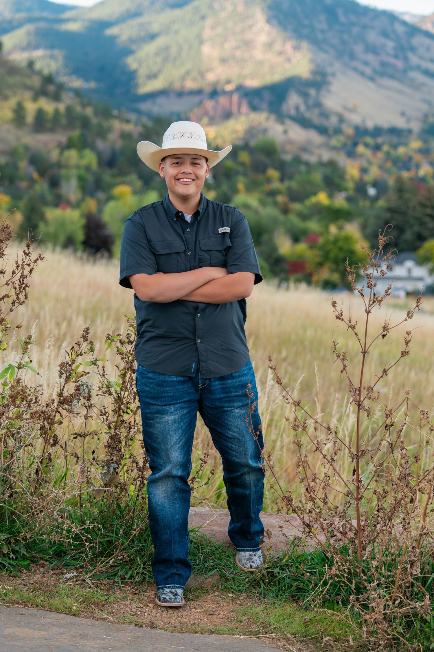 High school senior portrait in mountain field during an outdoor senior photography session captured by a Colorado senior photographer.