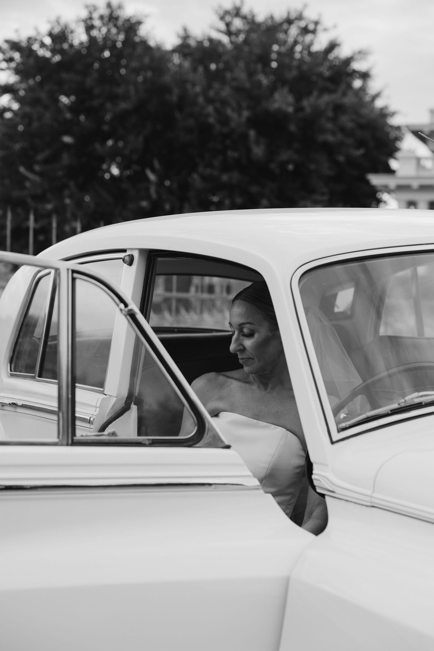 A black and white photo series showing someone looking out the window of a classic car.