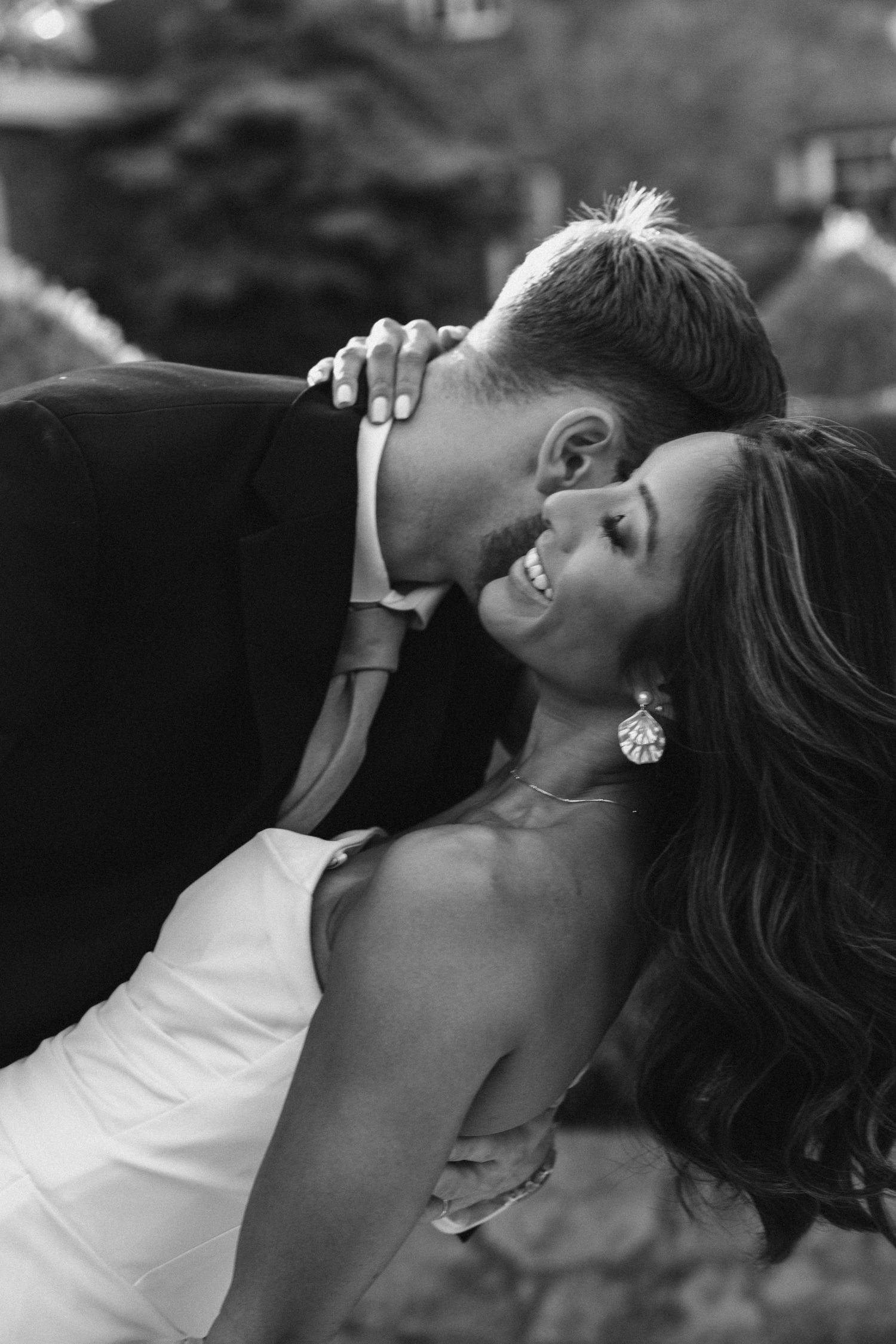 A black and white photo showing a couple embracing.