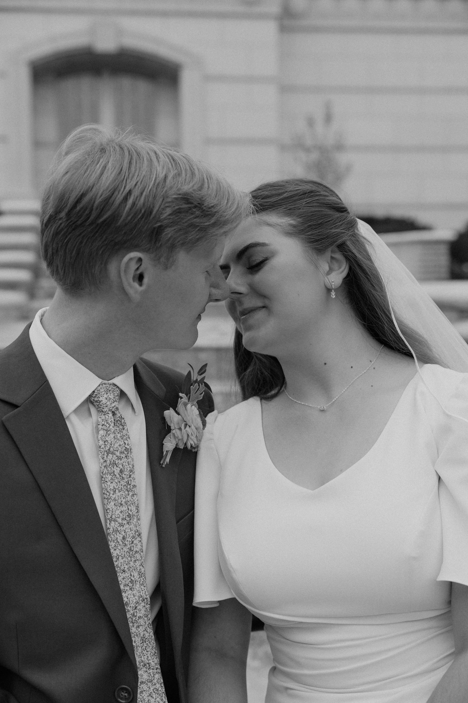 A black and white wedding photo sequence showing a couple in intimate close-up moments.