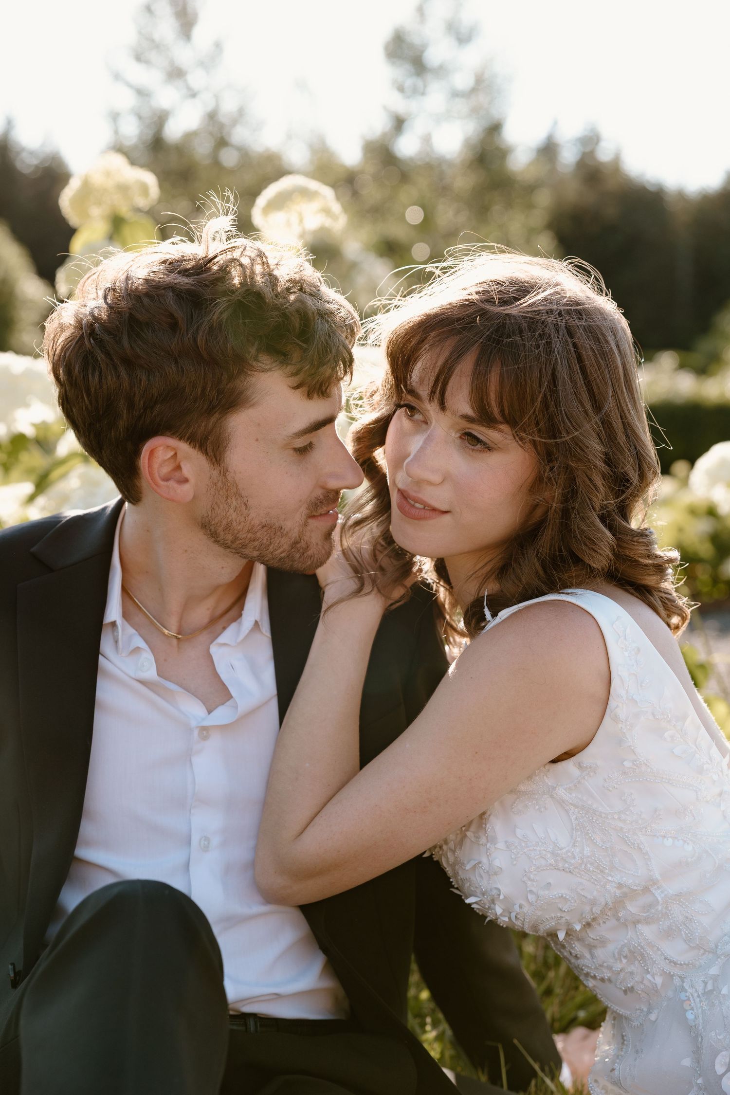 A romantic wedding couple shares intimate moments in a series of sunlit outdoor photos.