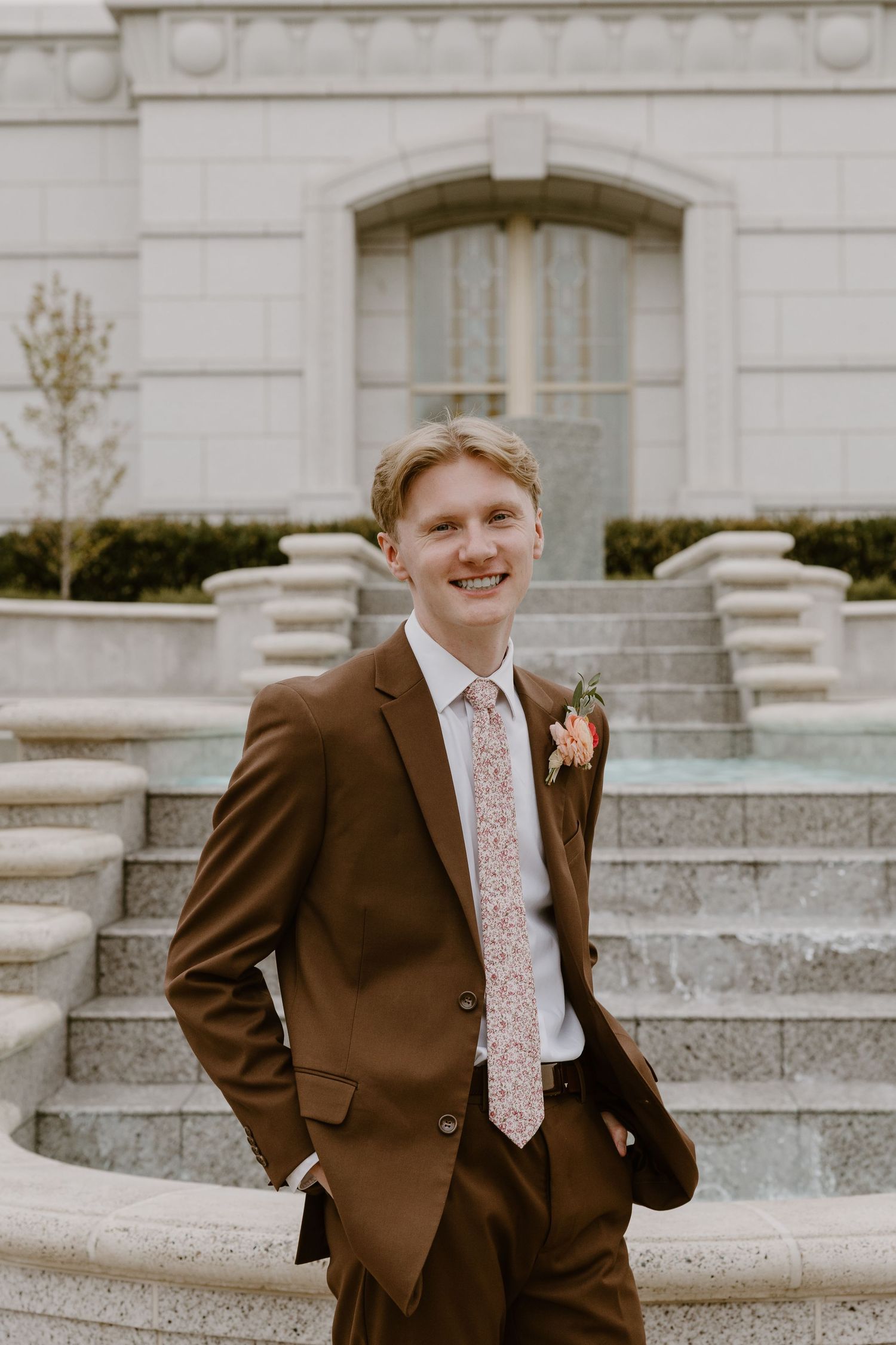A brown-suited figure poses on stone steps near a classic architectural building in a vintage-style photo series.