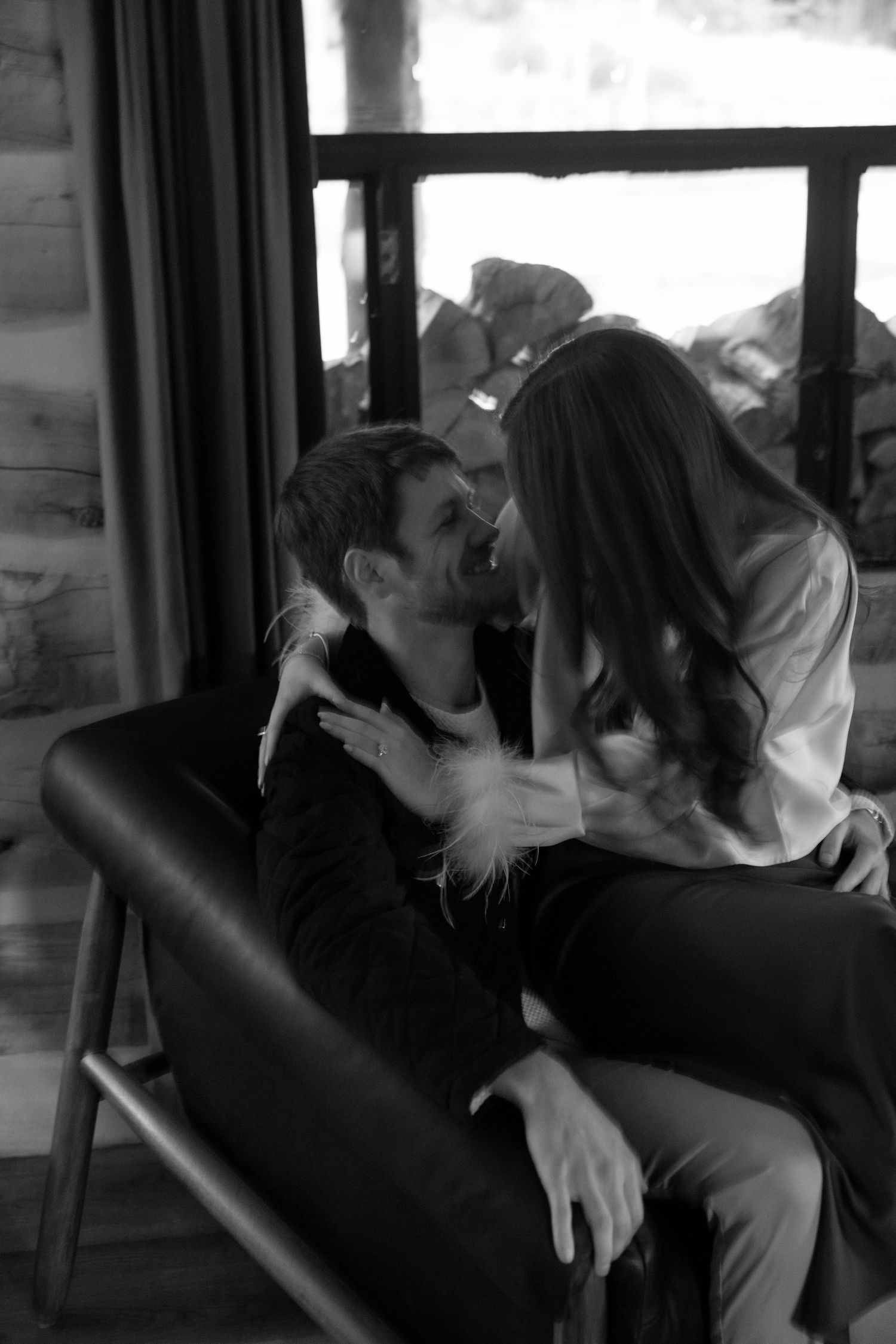 Intimate moments captured in black and white inside a rustic cabin setting.