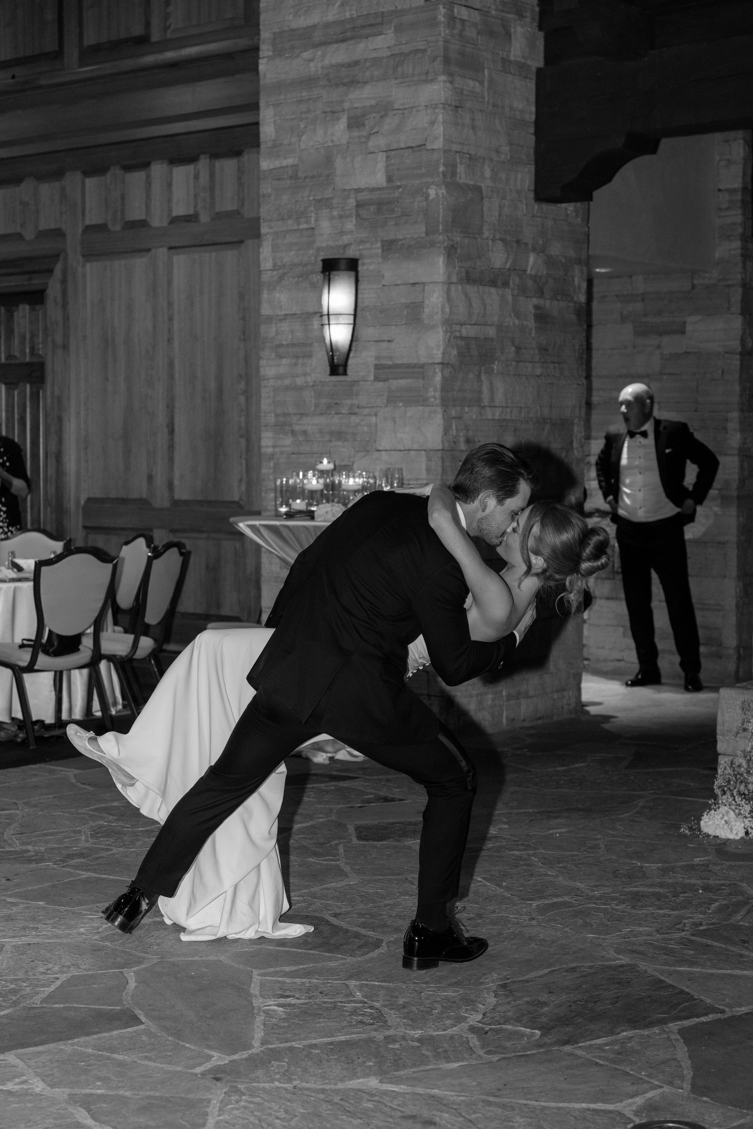 Black and white photo of creative dance moves on stone patio at night.