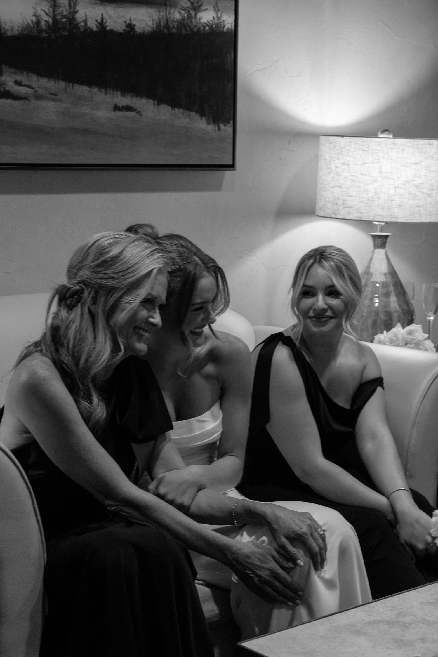 Black and white candid moment at formal event with interior lighting.