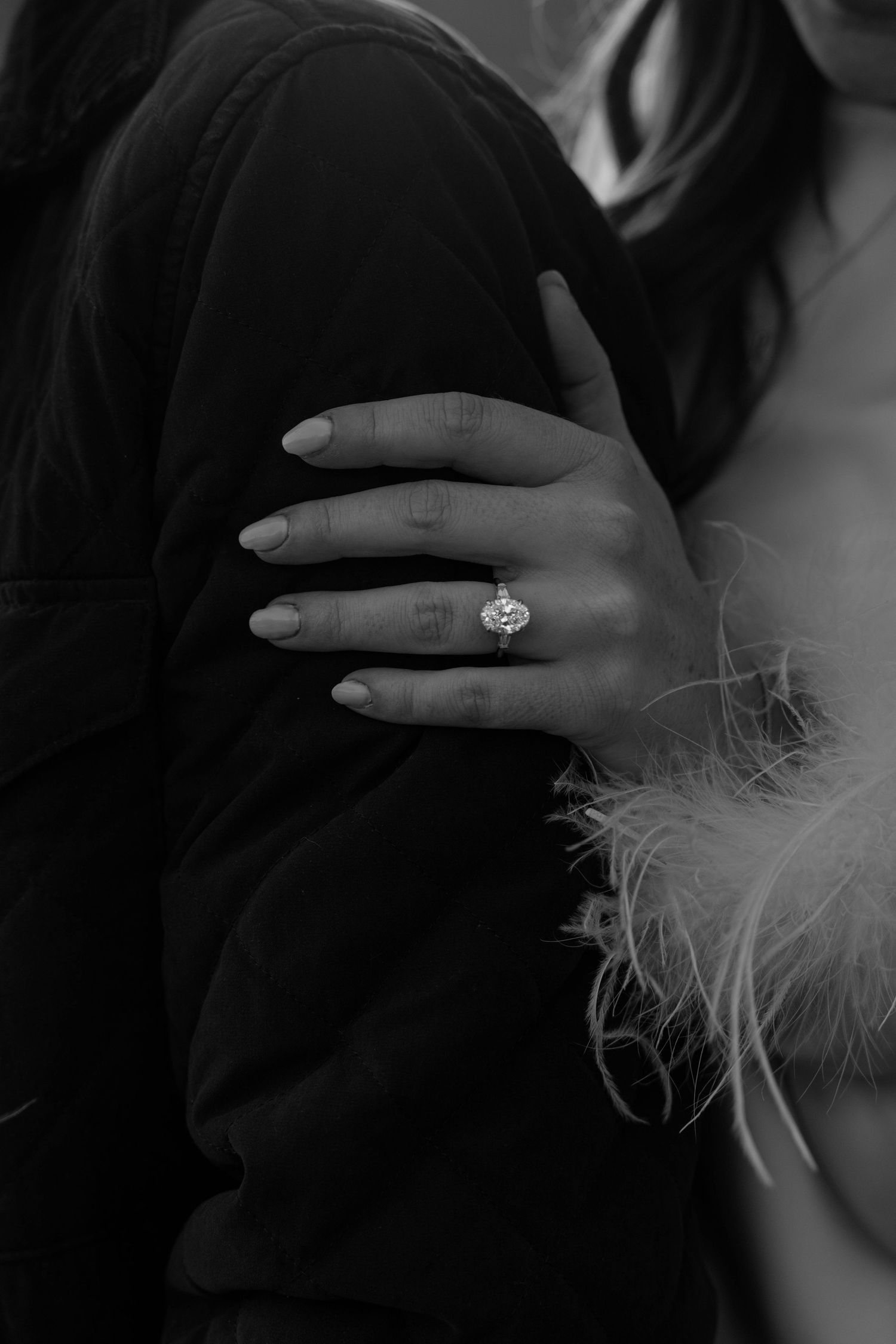 Close-up shots of an engagement ring with delicate feather details in black and white.