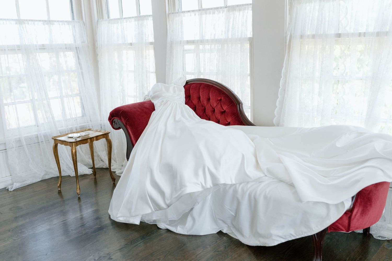 White fabric flowing and draped across a bright studio space.