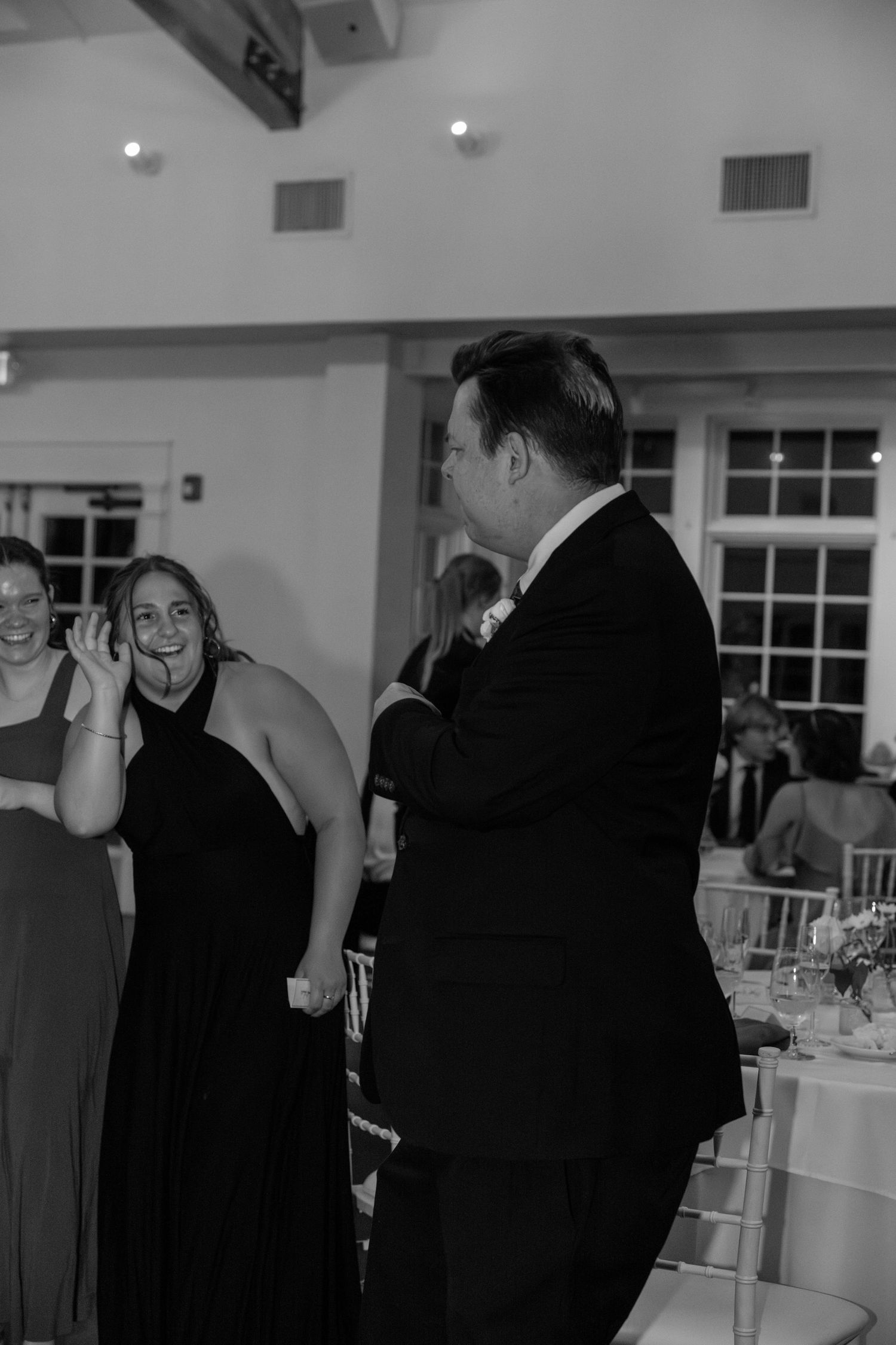 Wedding guests socializing and dancing at an evening reception.