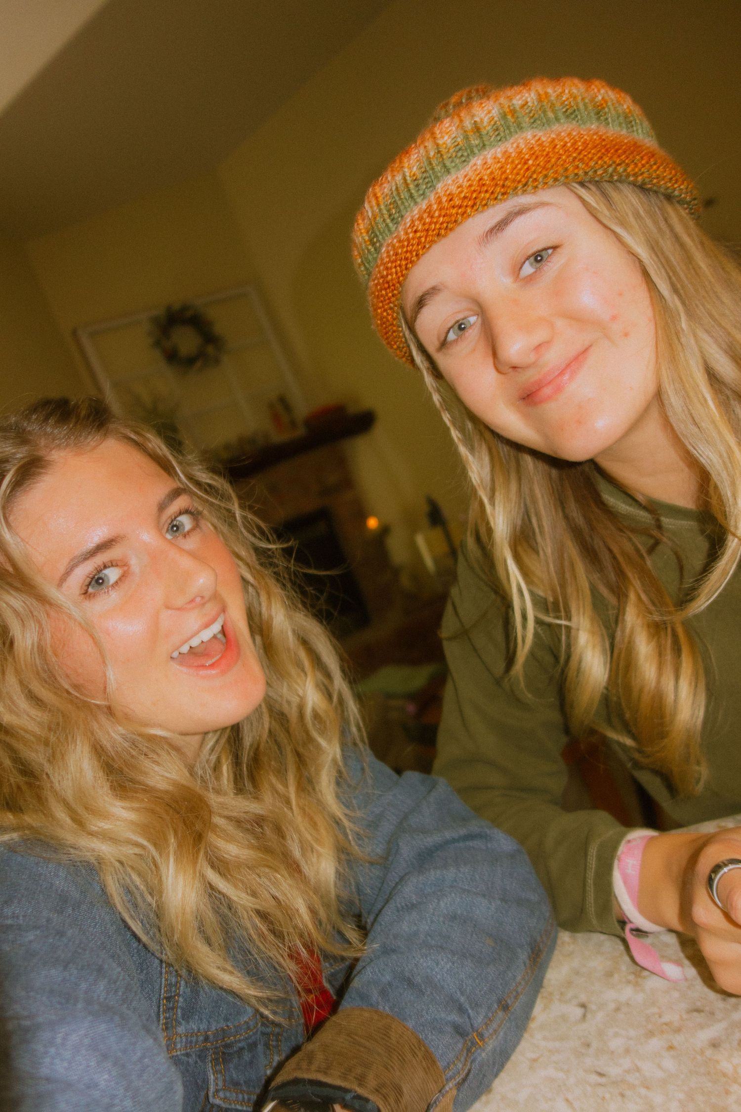 A series of selfie photos showing someone wearing a denim jacket and orange beanie in warm lighting.
