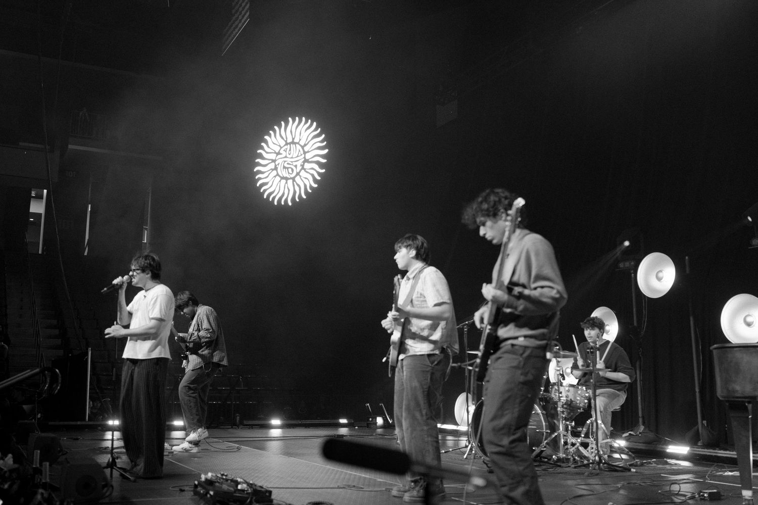 Black and white concert performance photos showing musicians on stage with instruments and lighting effects.