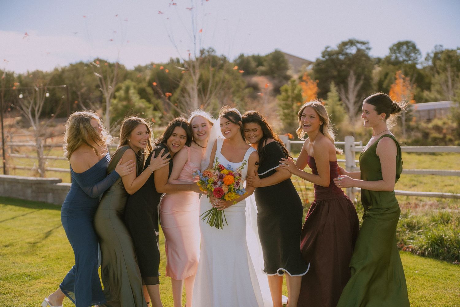 Wedding celebration in a scenic outdoor setting with mountains and fall foliage in the background.