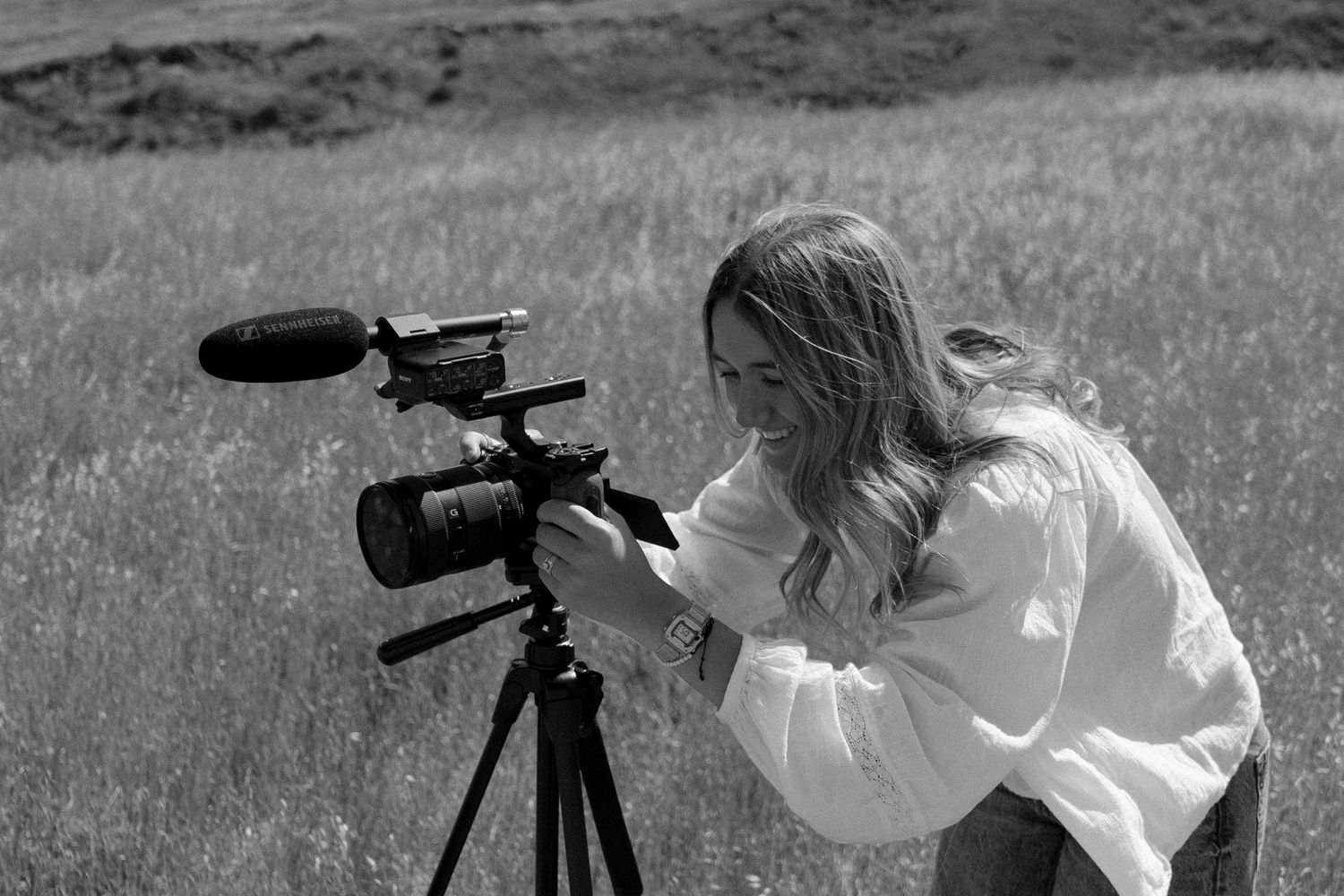 A series of black and white images showing someone looking through a telescope in a grassy field.