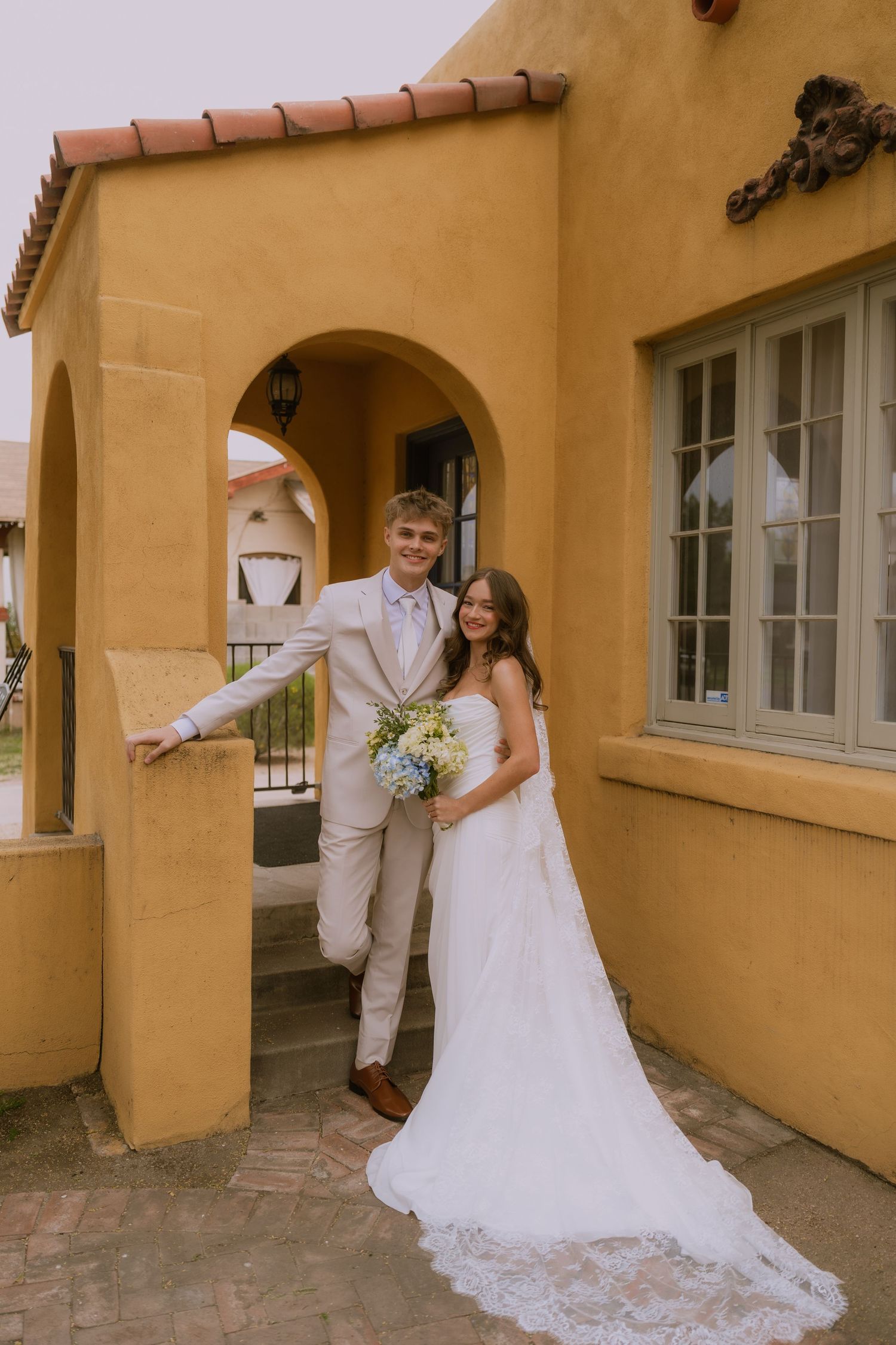 A series of wedding photos showing a couple posing in front of a yellow stucco building with arched doorways.