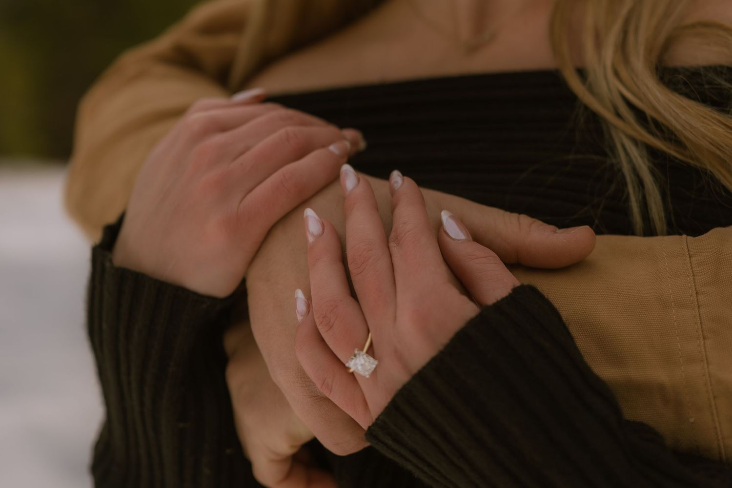 Close-up shots of hands wearing engagement rings, showing different angles of diamond solitaire rings.