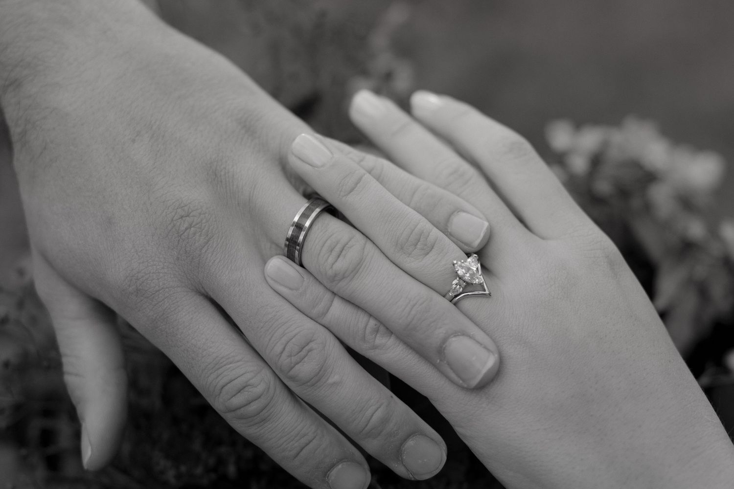 Black and white close-up photos of hands wearing engagement rings arranged in a horizontal collage.