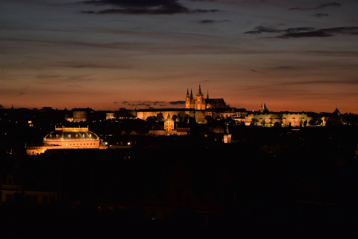 Noční panoramatický výhled z terasy hotelu na osvětlený Pražský hrad. Fotografie exteriérů a výhledů.