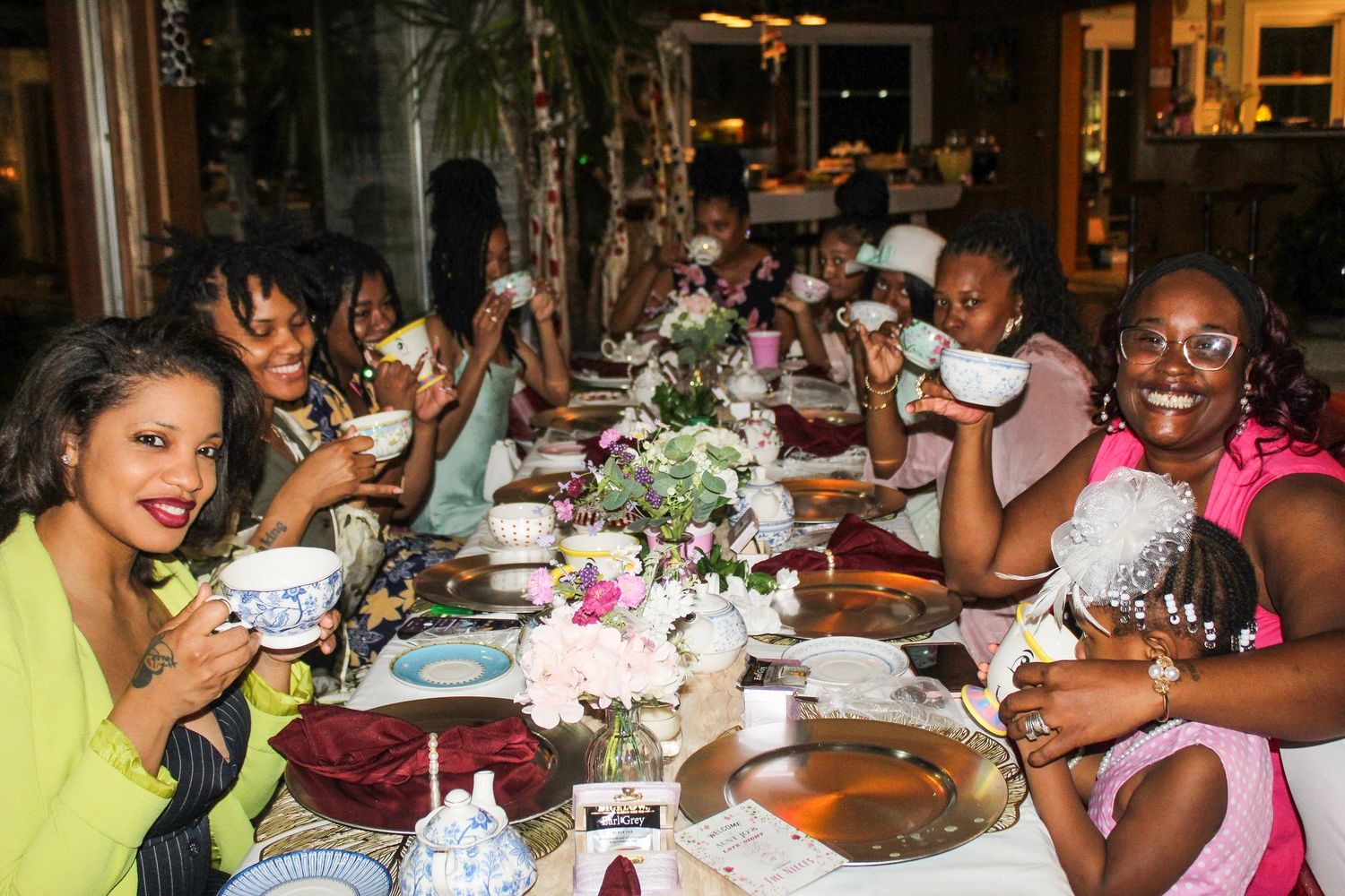 Guests seated at decorated dining tables during an evening social event.