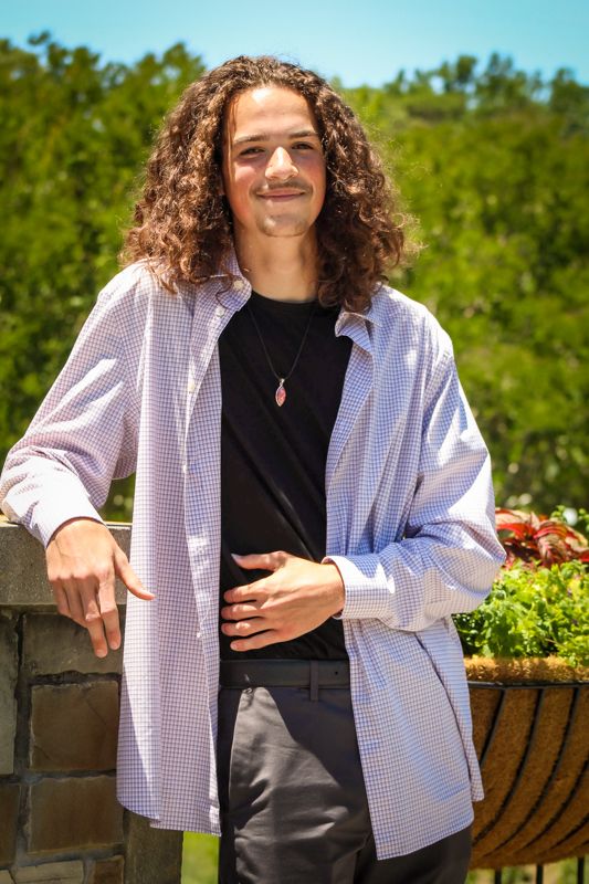 Portrait series in a garden setting with pink gingham jacket and black top.