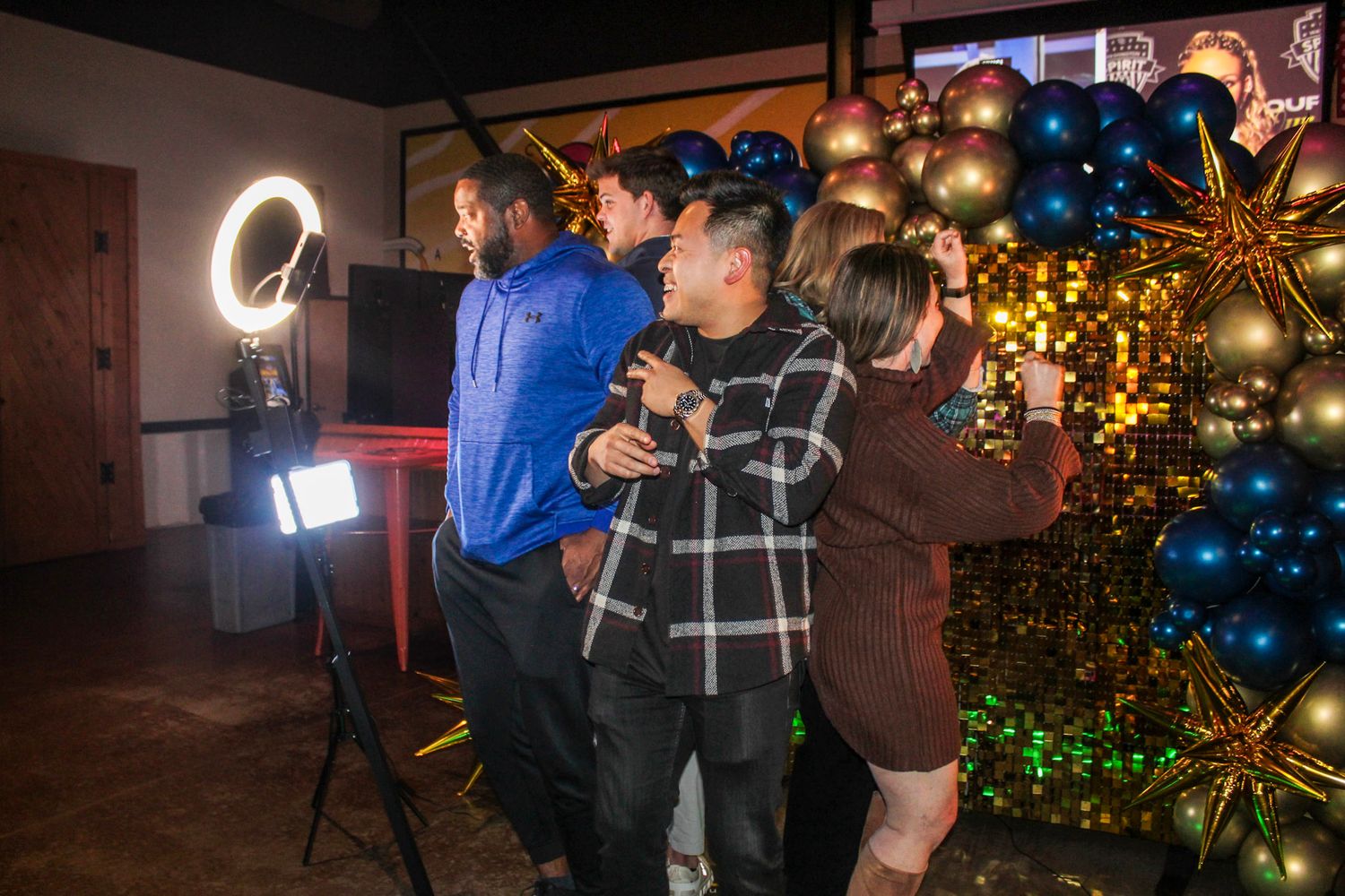 A sequence of photos showing a couple posing and dancing together at a holiday party with Christmas trees in the background.