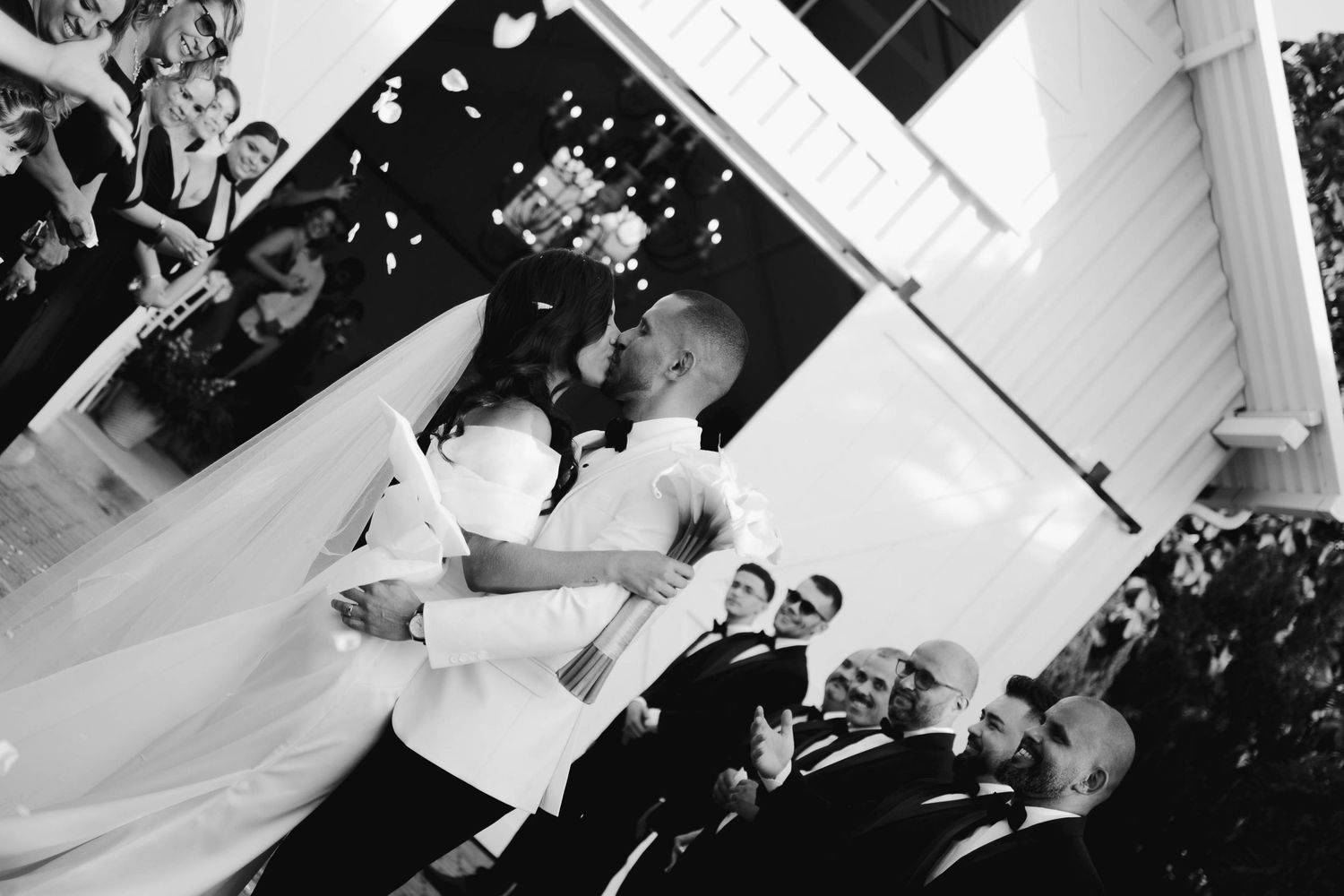 A sequence of black and white wedding photographs showing dance floor moments and celebrations at a reception.