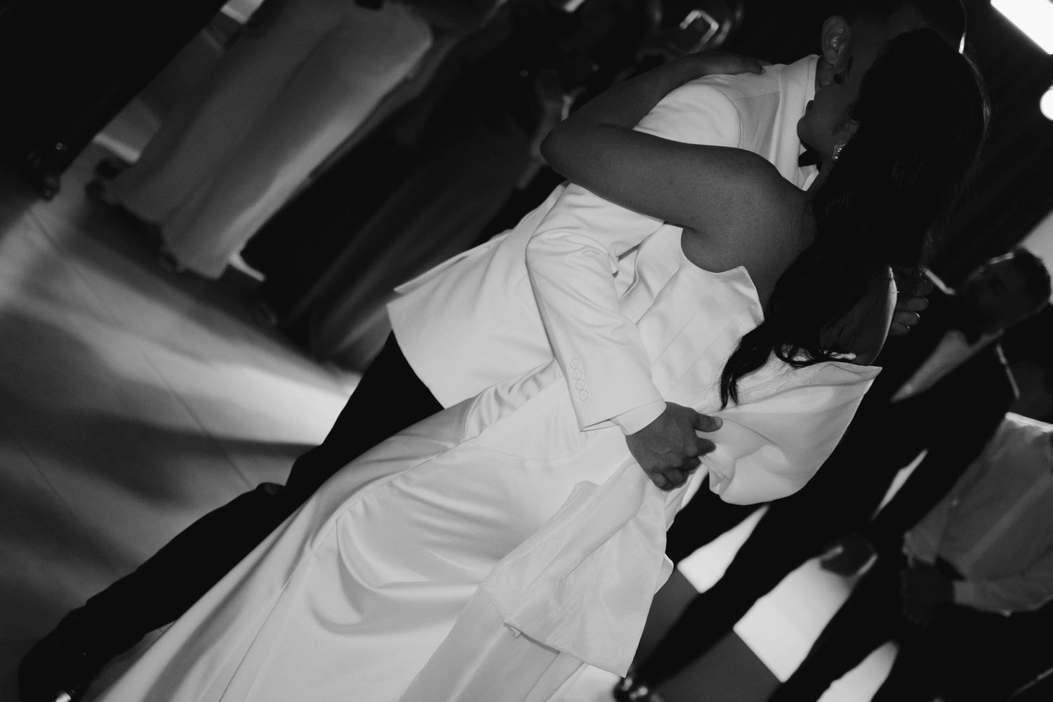 Black and white dance floor photos showing couples celebrating at a wedding reception.