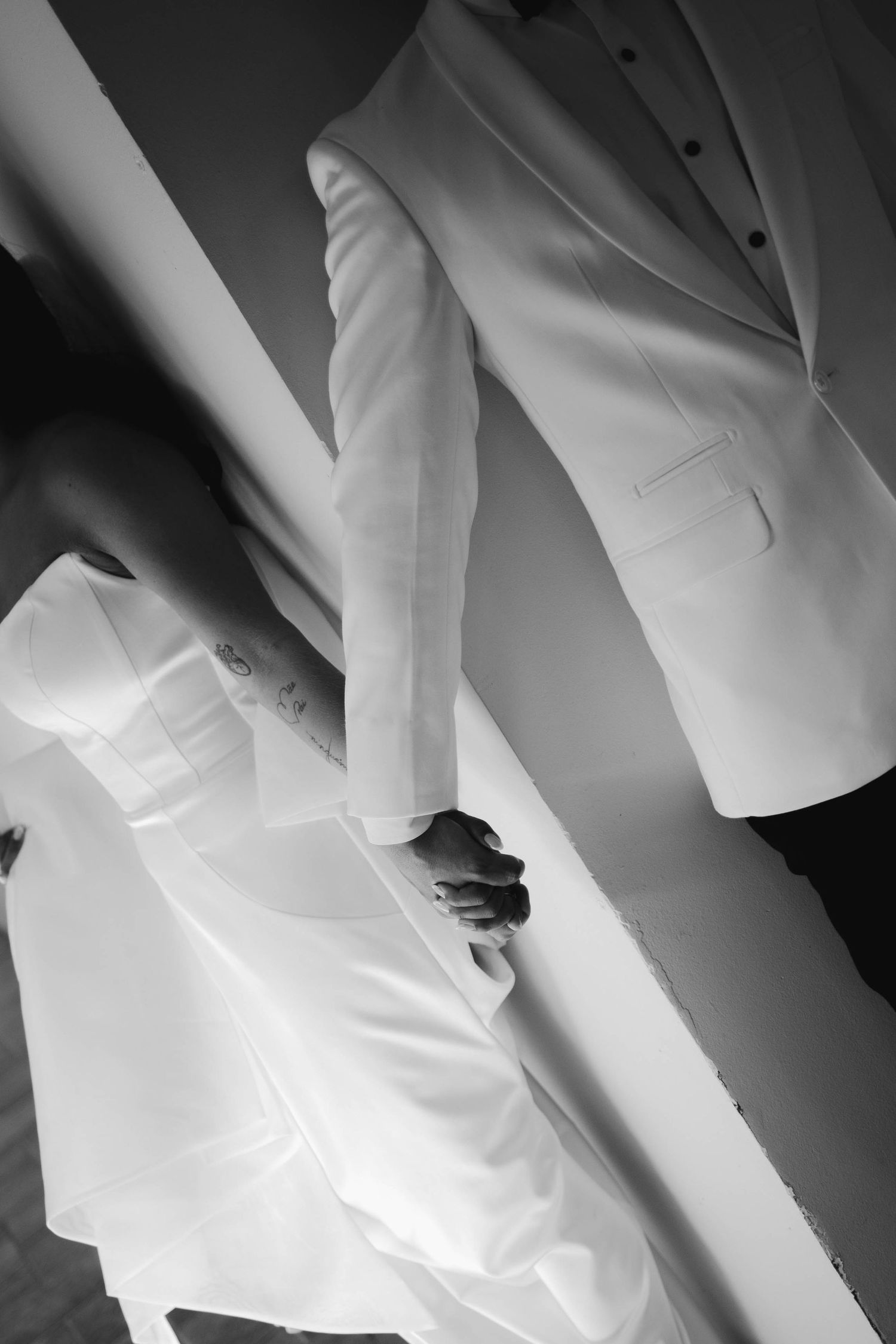 Abstract black and white details of formal white wedding attire.