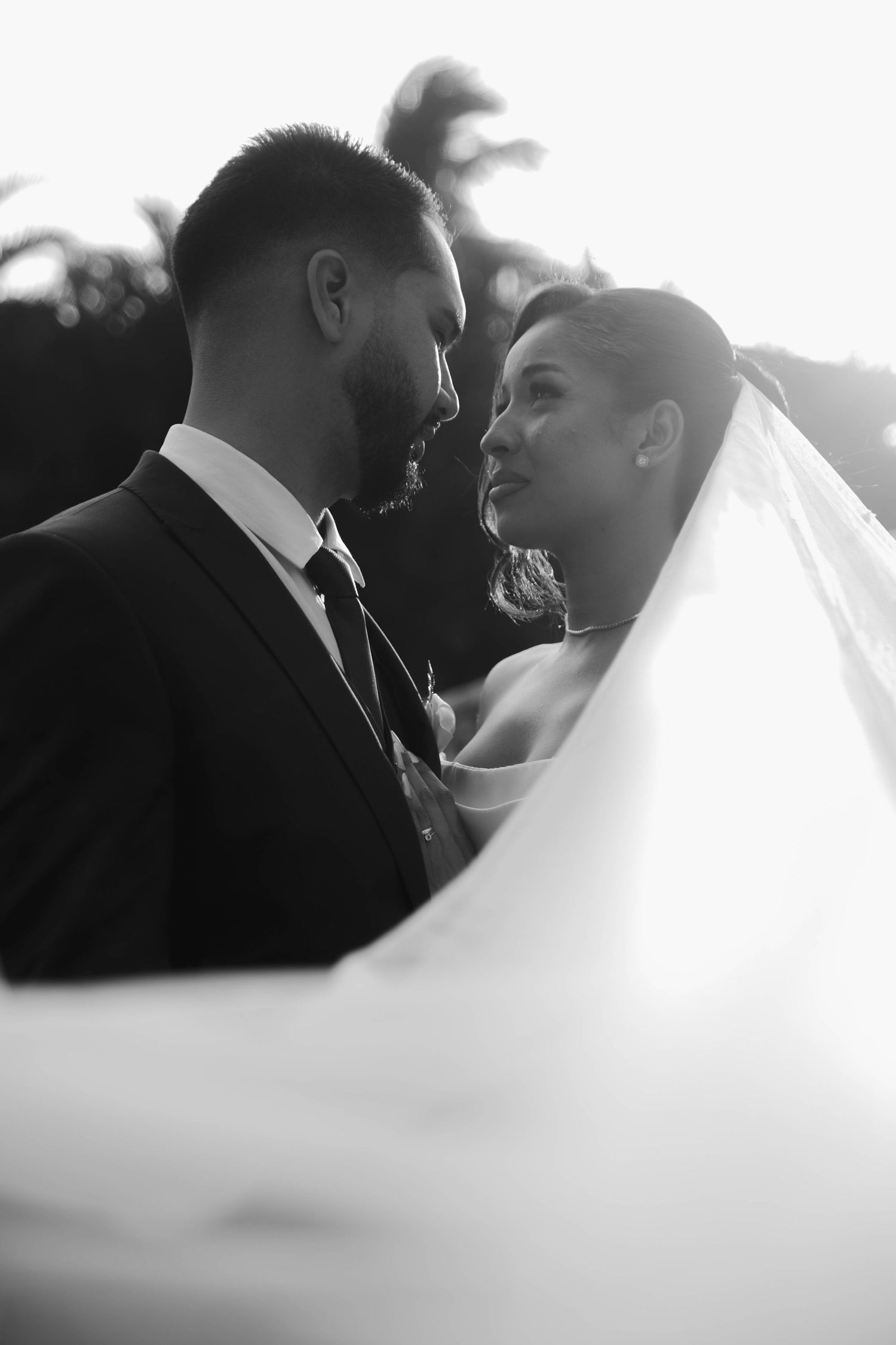 Black and white wedding photography sequence showing romantic close-up moments between newlyweds in soft focus.