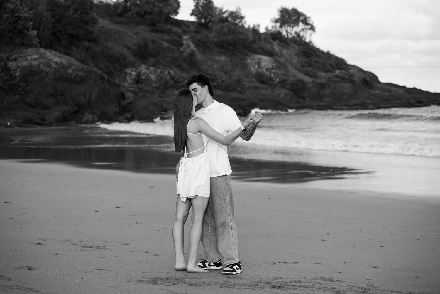 Couple dancing on the beach during their couple photo session in Kiama.