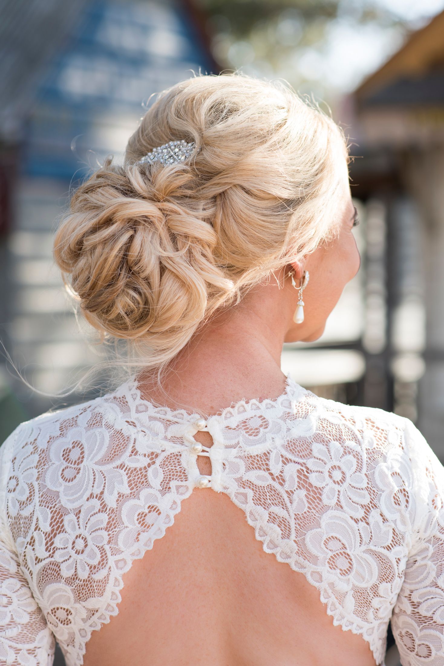 A series of detailed shots showing the delicate lace back of a white wedding dress with elegant upswept hairstyle.