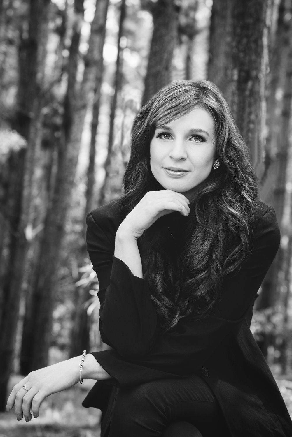 Black and white portrait in forest setting.