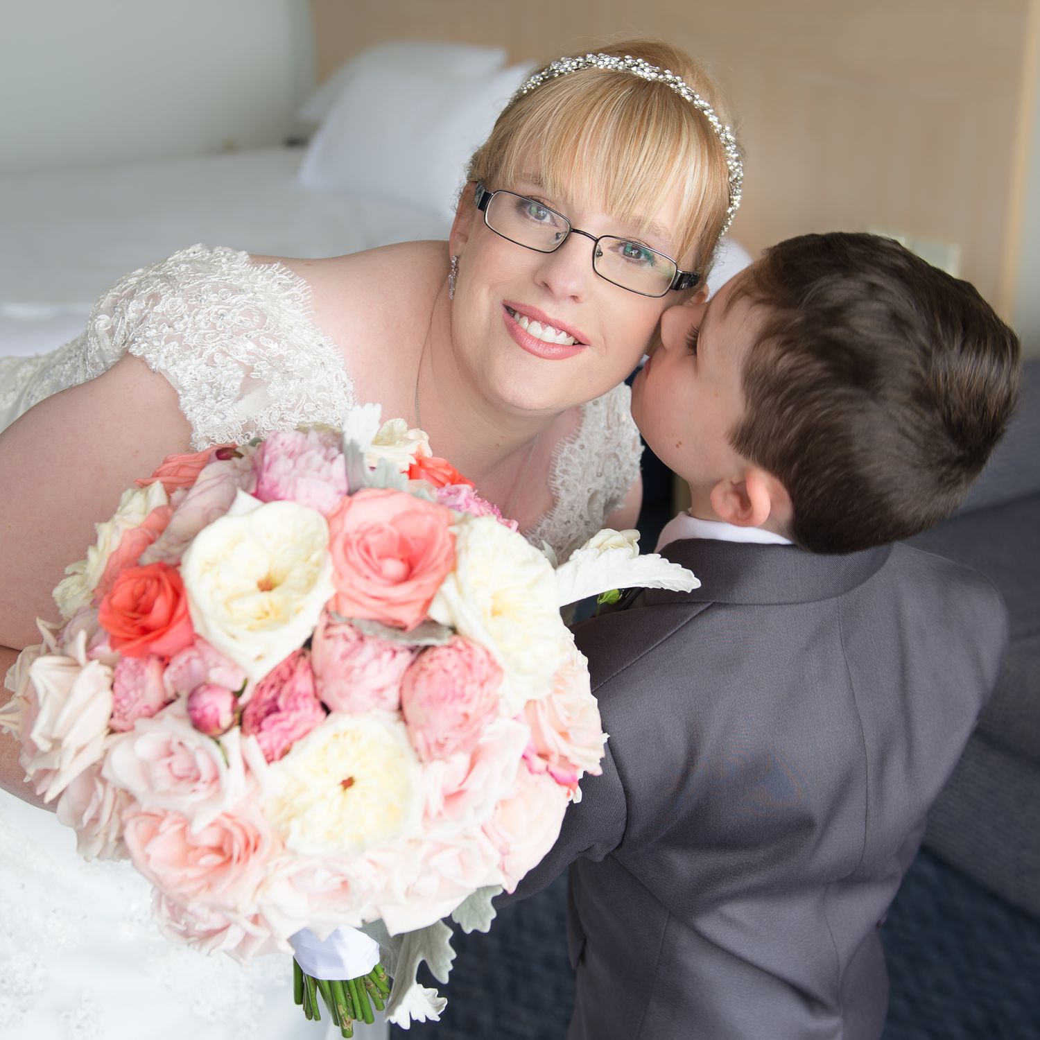 A romantic wedding photo series showing tender moments between mother and son with pink and peach floral bouquets.