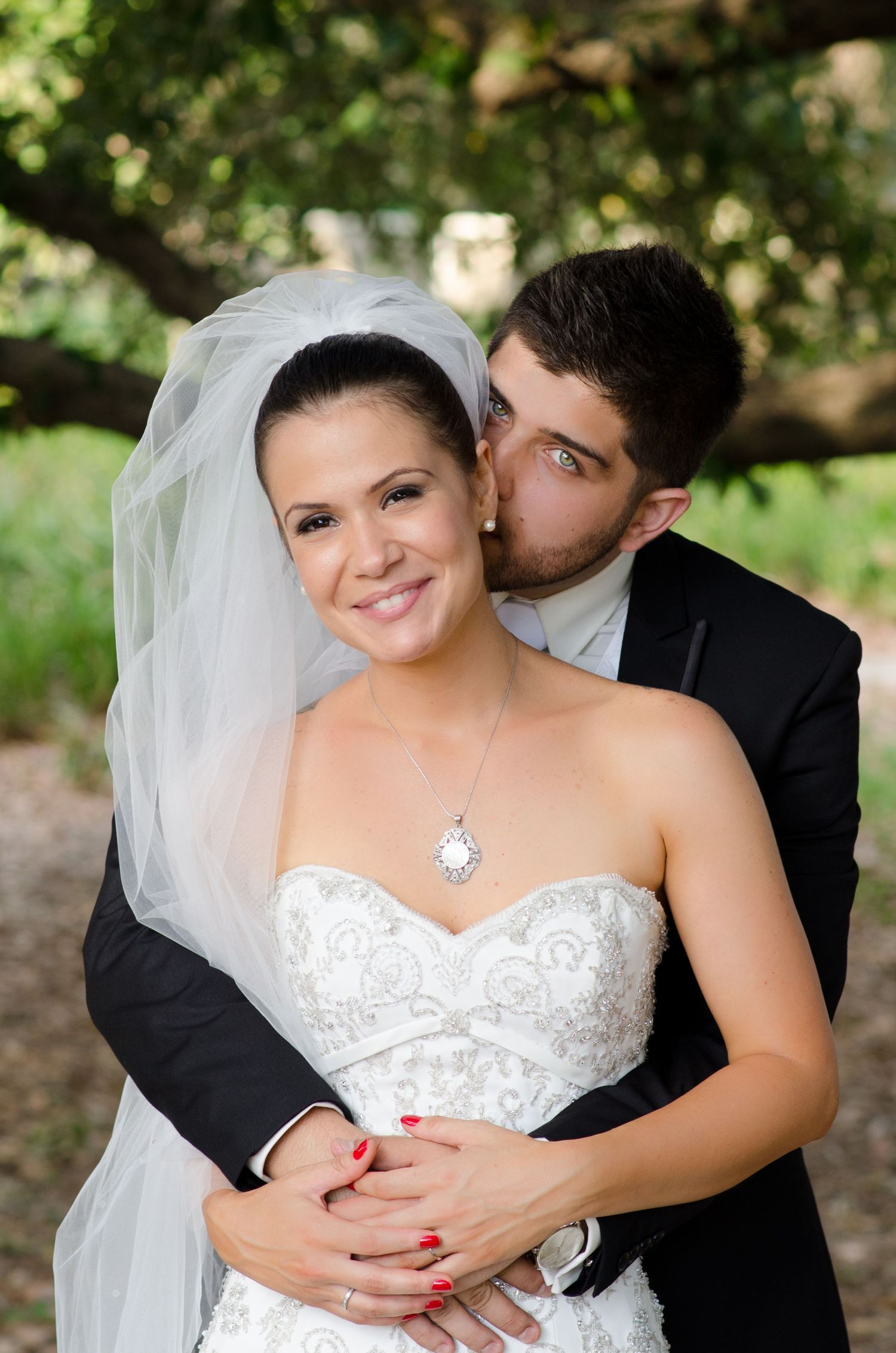 Intimate wedding couple portraits captured in a natural outdoor setting.