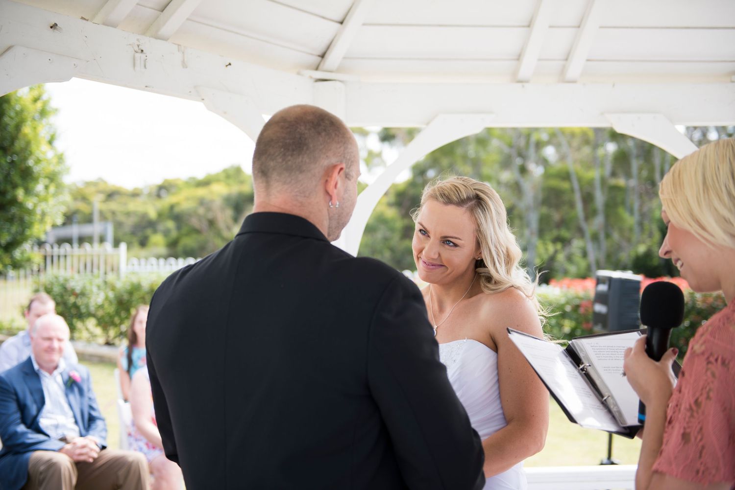 Bride and groom under gazebo during wedding ceremony at Panorama House.