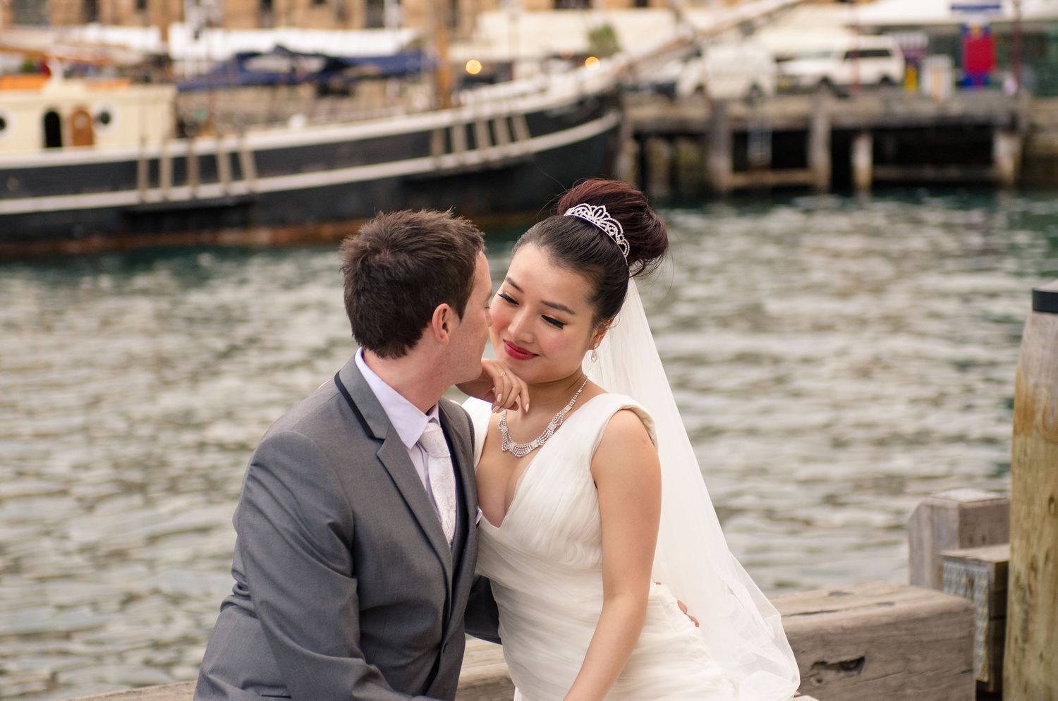 Romantic waterfront wedding moments captured along a wooden dock.