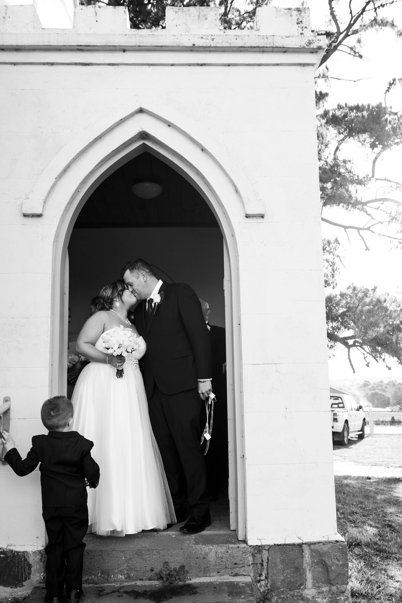 A series of romantic black and white wedding photos showing couples in church archways and doorways.