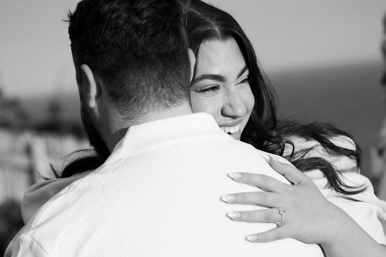 A black and white photo series showing a couple embracing and sharing emotional moments together. Kiama engagement photography.