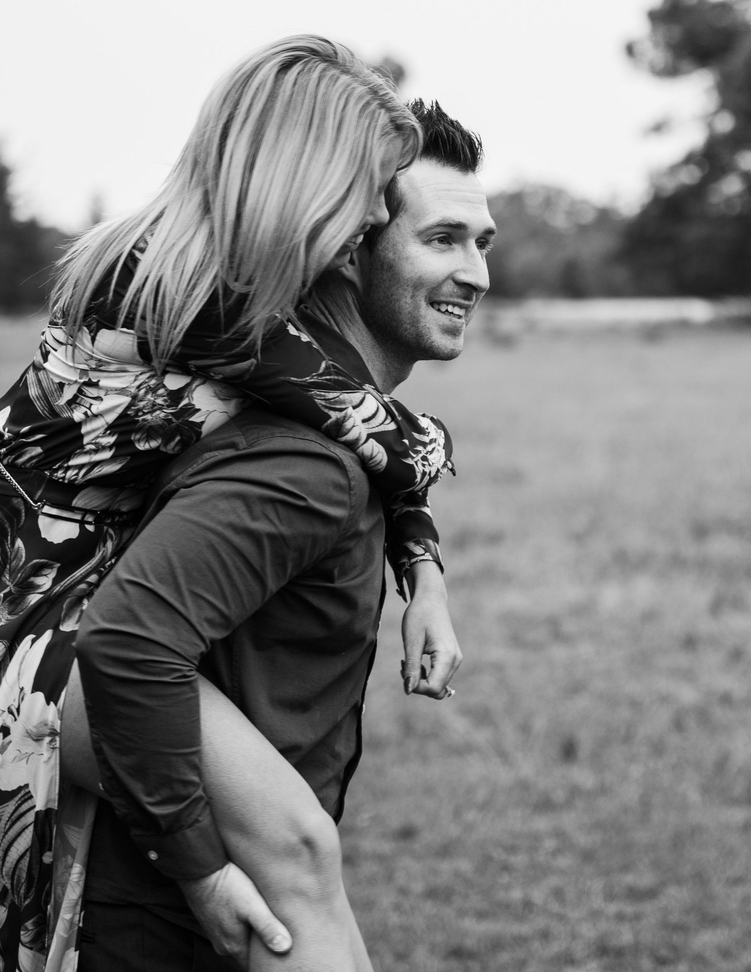Black and white candid shots of a playful couple laughing and embracing outdoors.