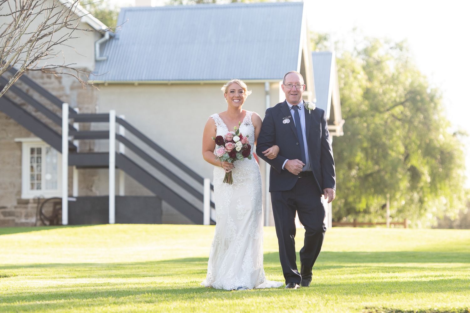 Bride with father walking her down the isle on her wedding day.
